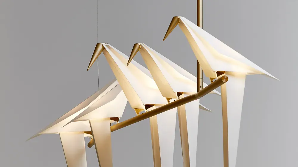 A light fixture in the shape of origami birds hanging from the ceiling.
