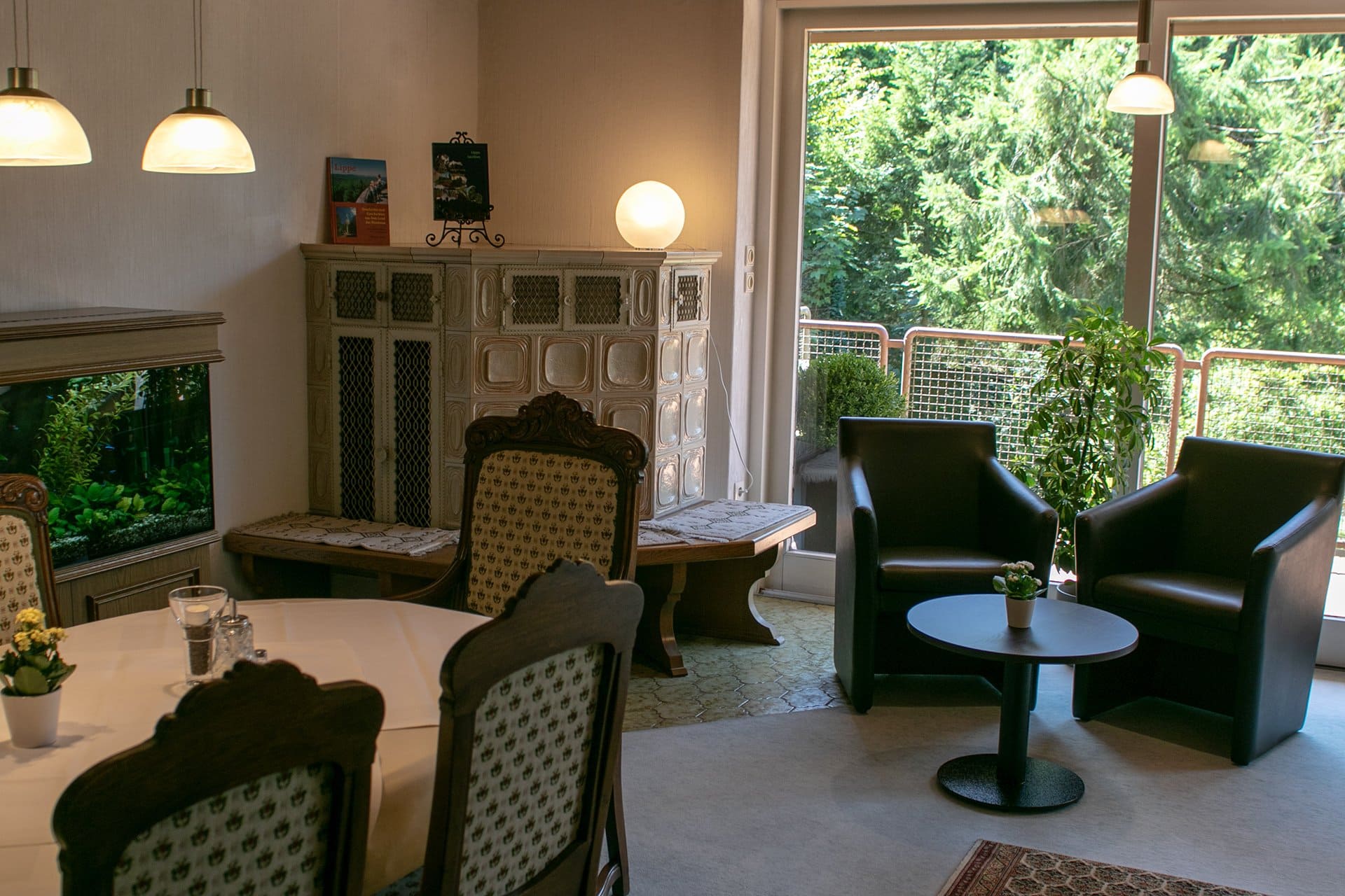 Ein Wohnzimmer mit Tisch und Stühlen und einem großen Fenster