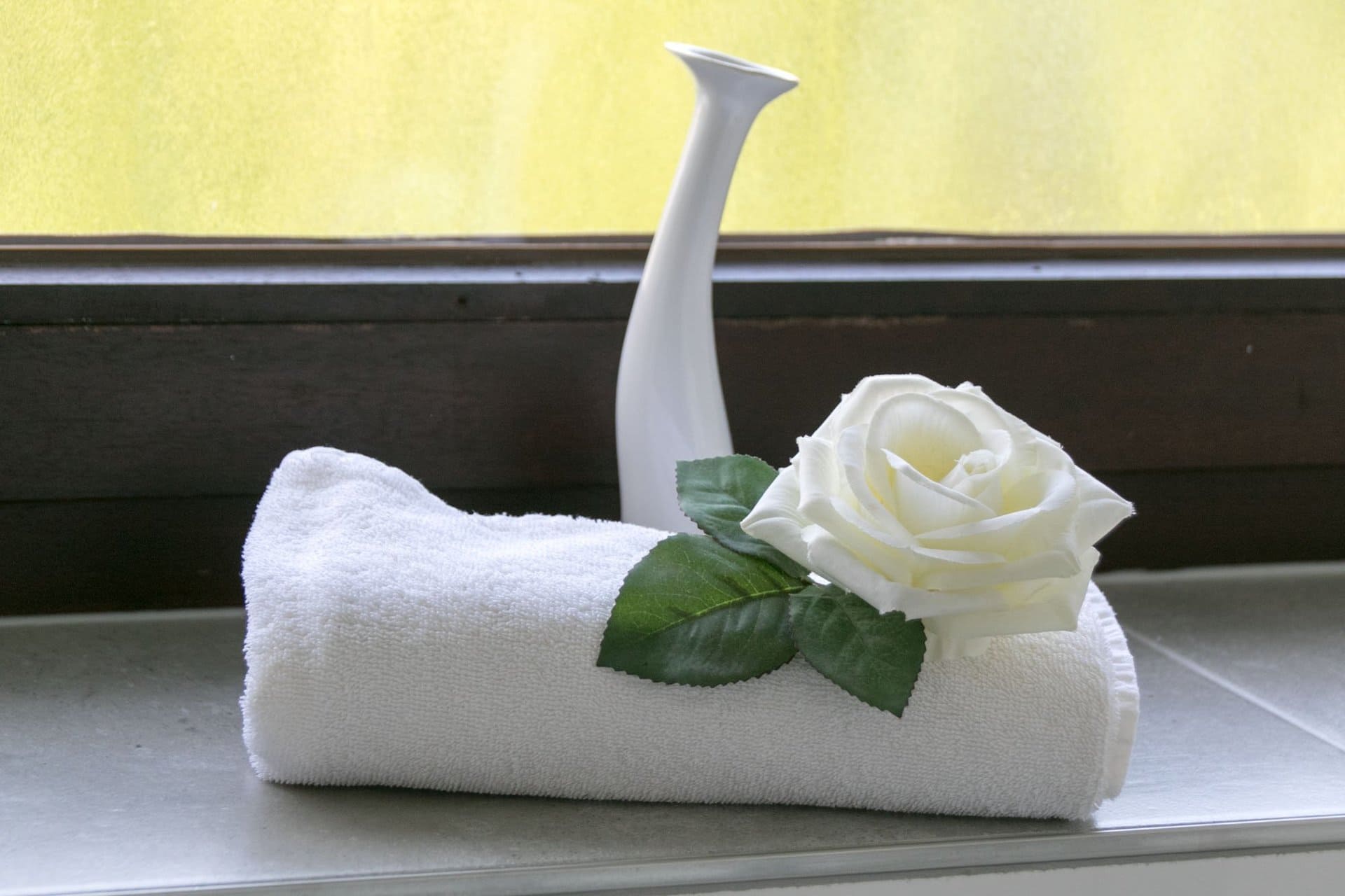 Ein weißes Handtuch mit einer weißen Rose darauf