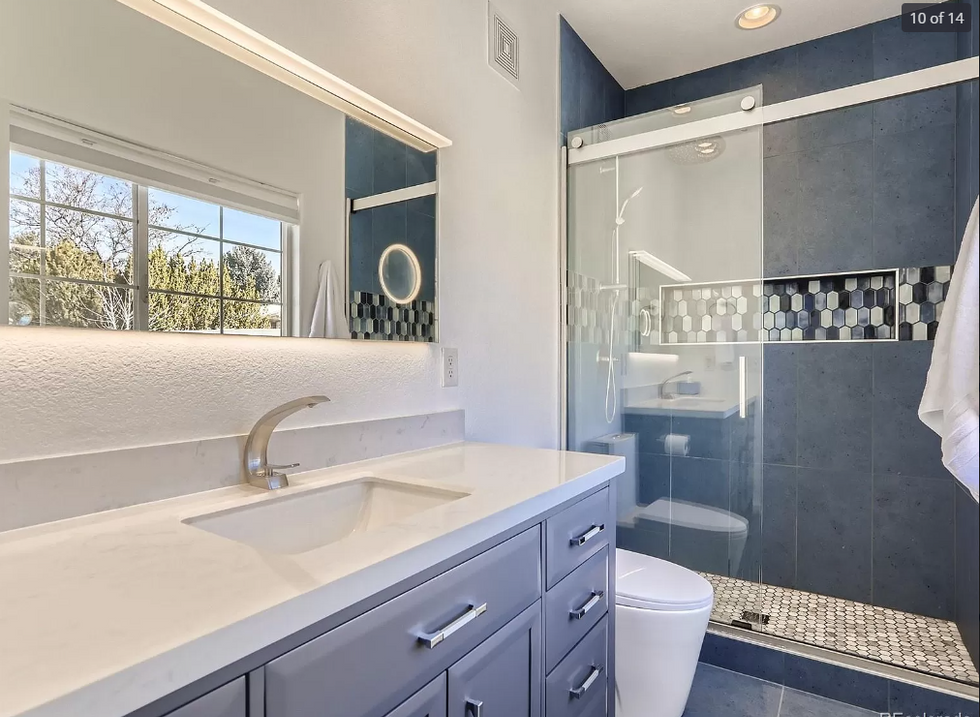 A bathroom with a sink , toilet and shower.