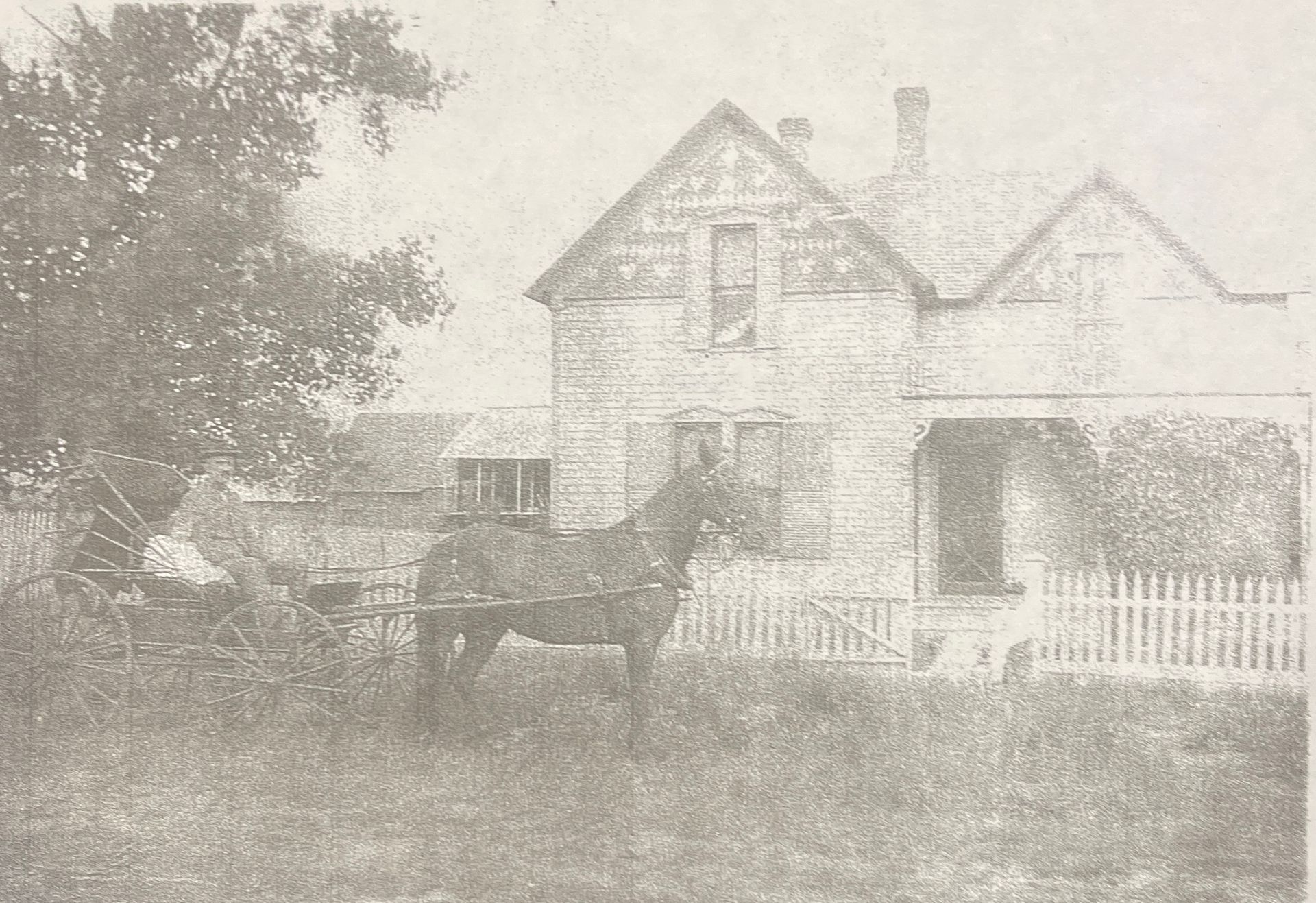 White house with American flag, front porch, and wreaths.