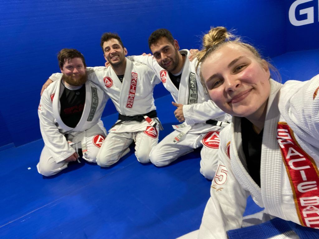 A group of people are posing for a picture on a blue mat.