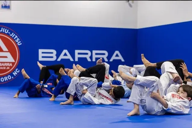 students practicing Jiu Jitsu on the mat at Gracie Barra Greensboro
