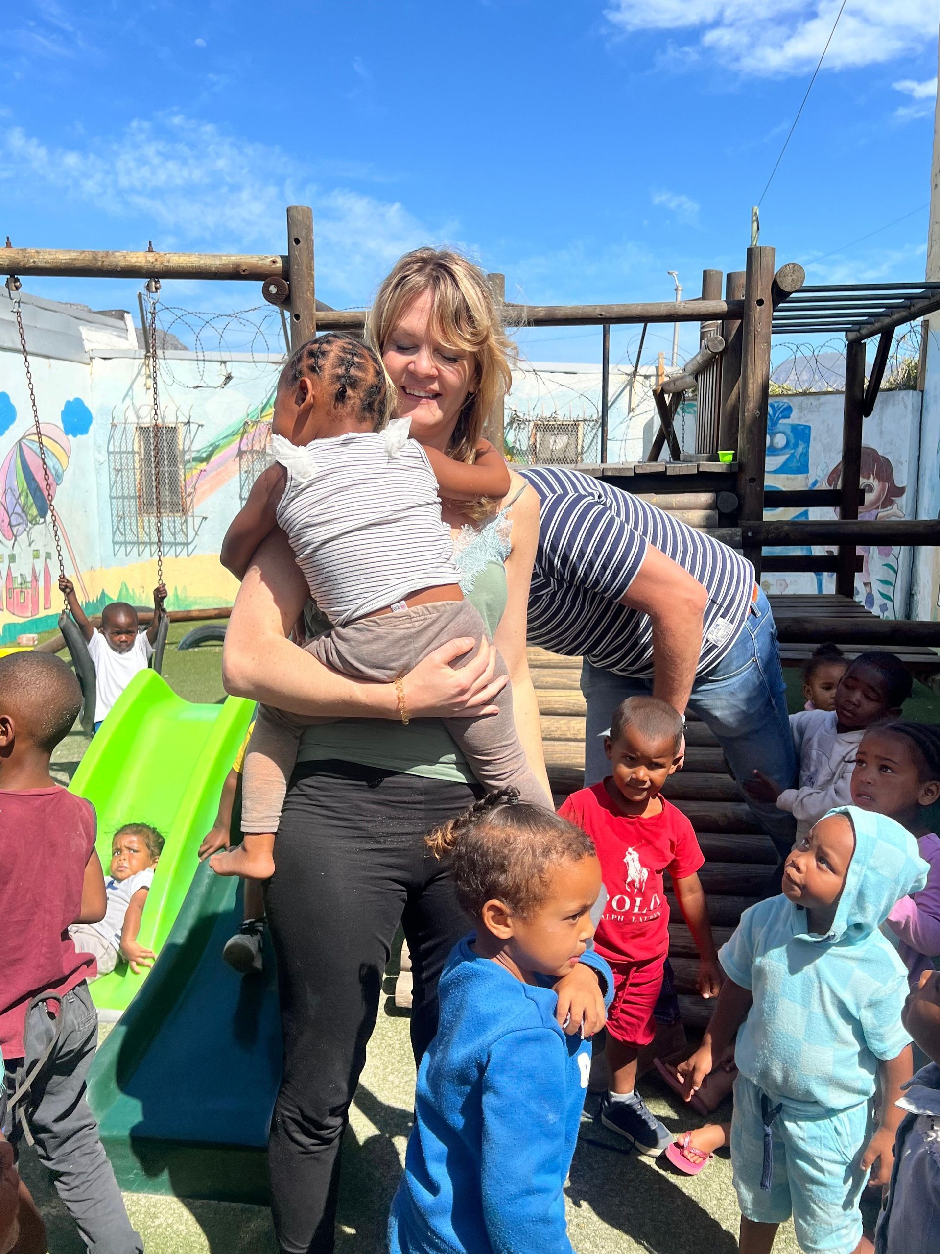 A young boy is drinking water from a faucet that says ' ethiopia ' on it