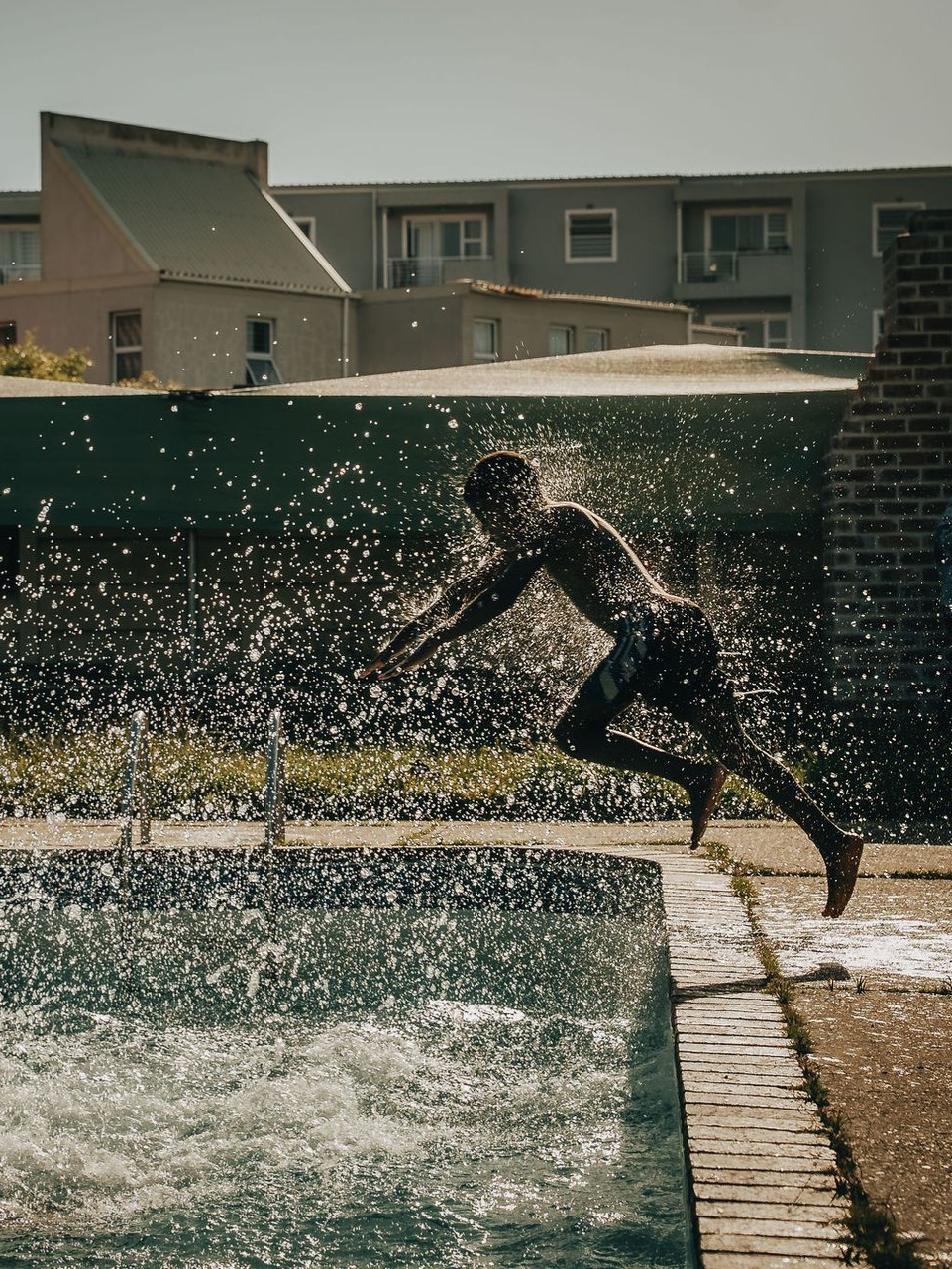 Two women are posing for a picture in front of a truck.