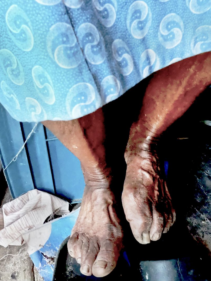 Two women are posing for a picture in front of a truck.