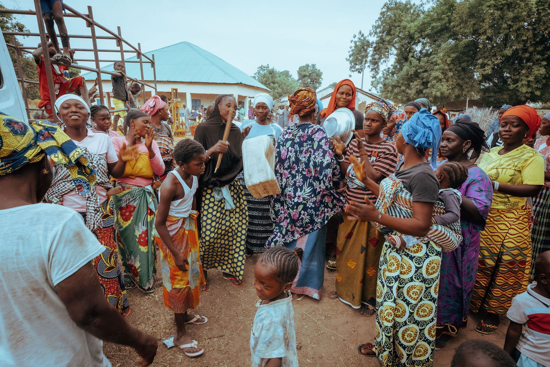 A group of people are dancing in a field.