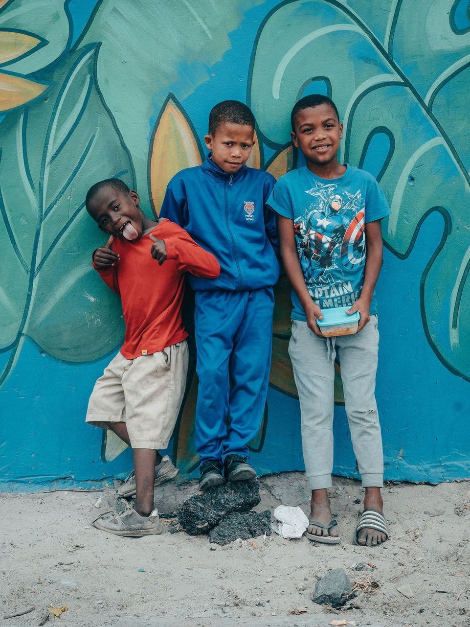 Two women are posing for a picture in front of a truck.