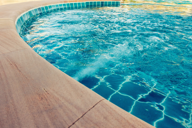 Picture of a concrete pool deck.  The picture is taken closeup.