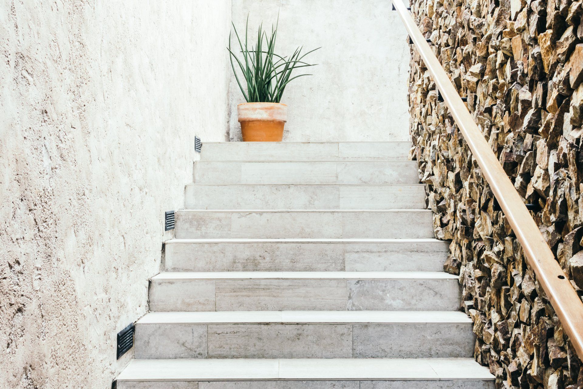 Picture of a concrete stairway leading up to the entrance to a building.