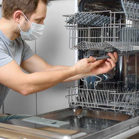 Man Fixing The Dishwasher