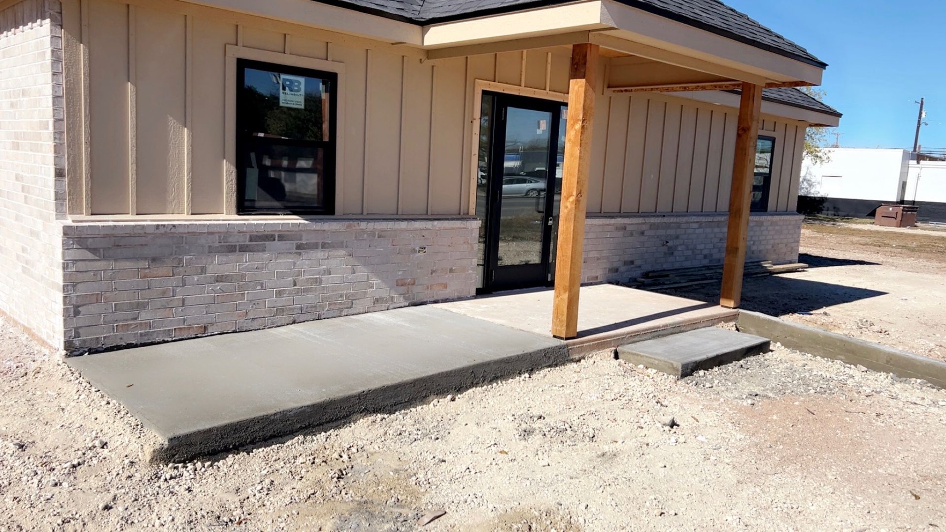 House under construction with exposed framing and yellow tape across the garage door.