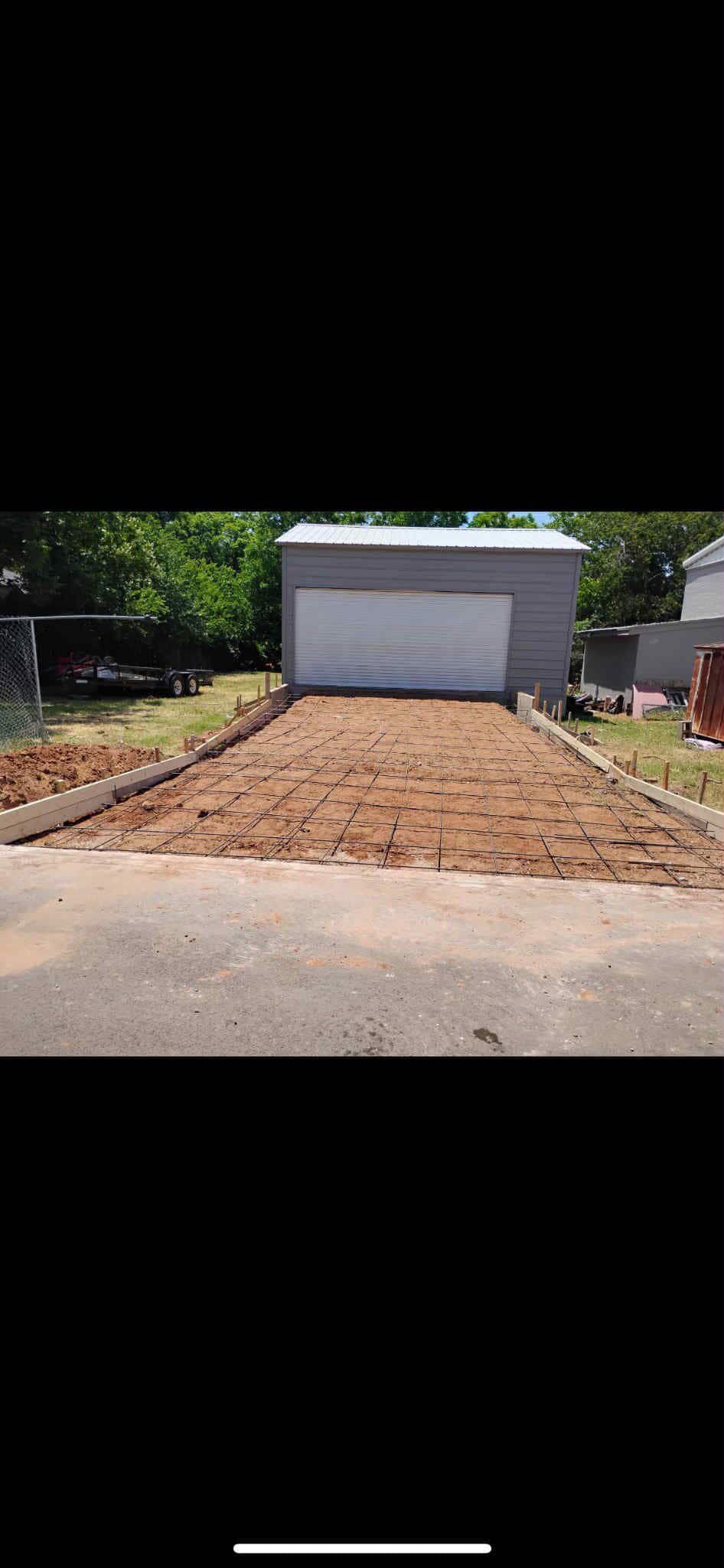 Tall beige building framed by two taller buildings, viewed from street level.