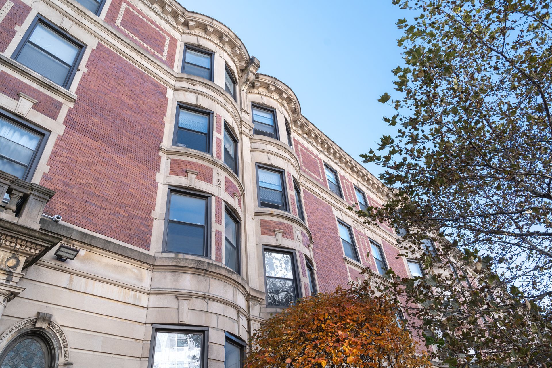 Photo of a large, multi-story building, looking up at the multiple floors from the street level