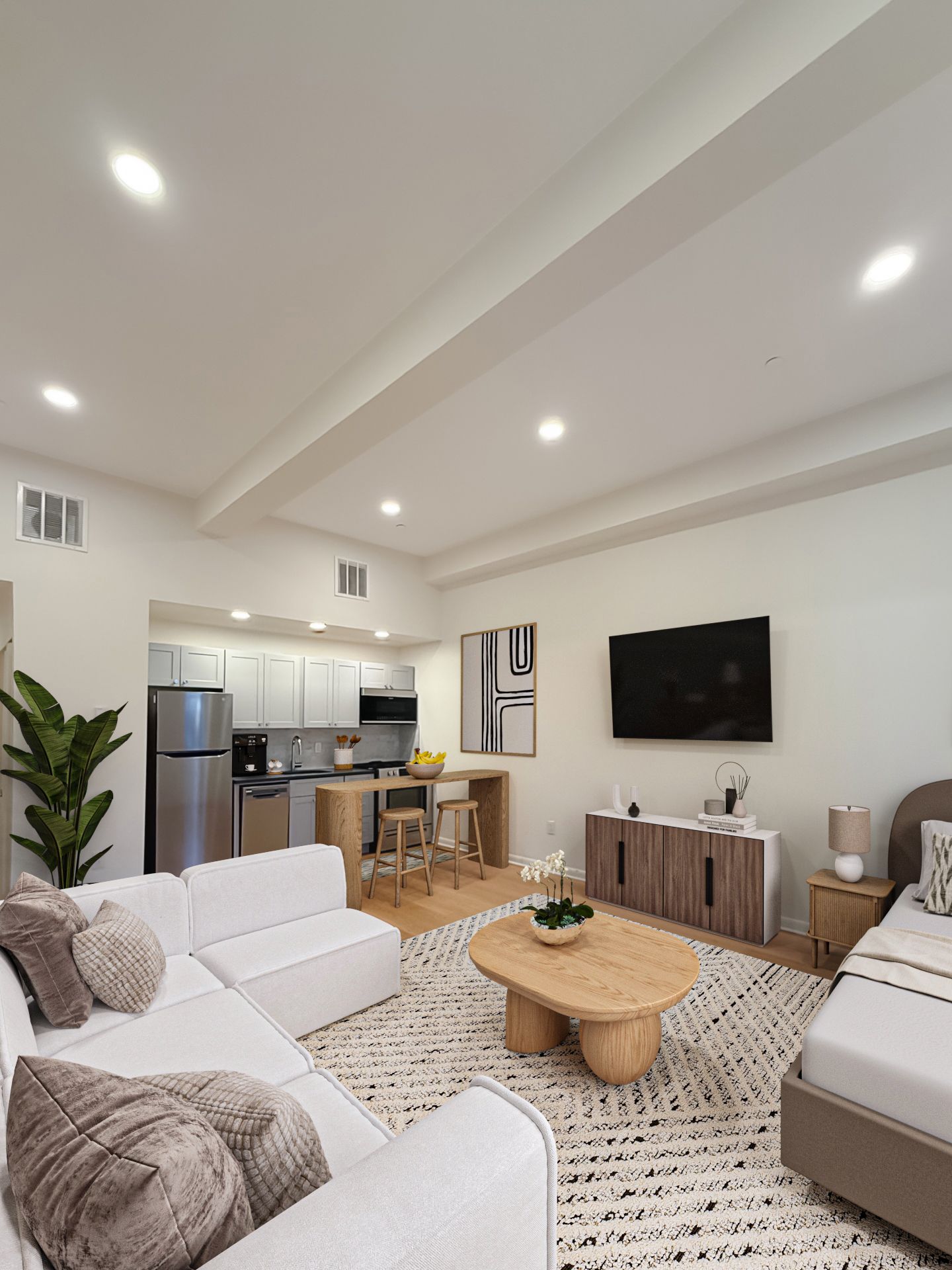 Photo of a living room with a kitchen in the background