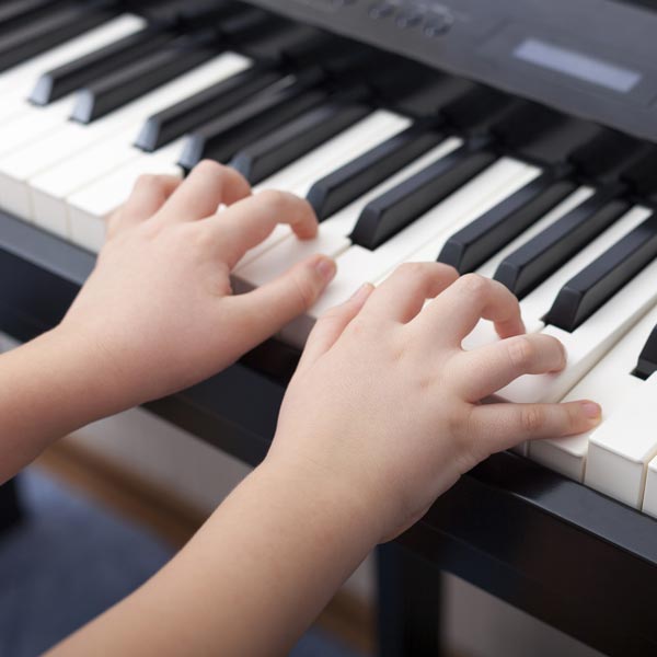 Child's hands on piano keys