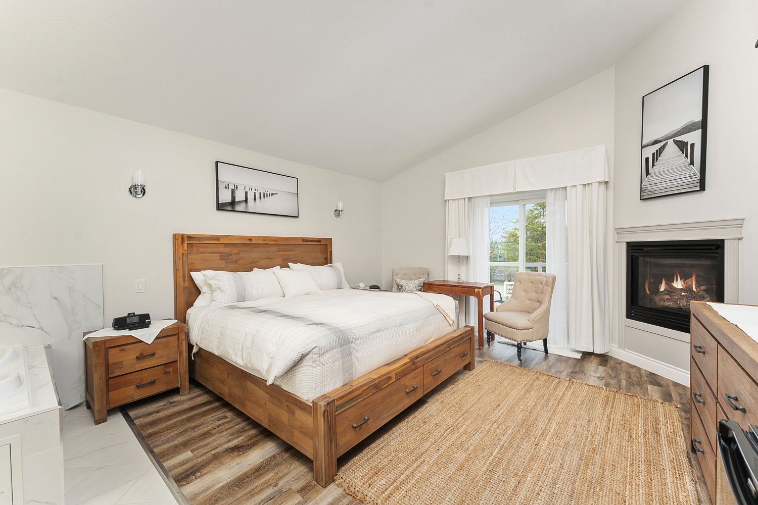 There is a large bed in the middle of the room. Lakeshore Inn Bed & Breakfast