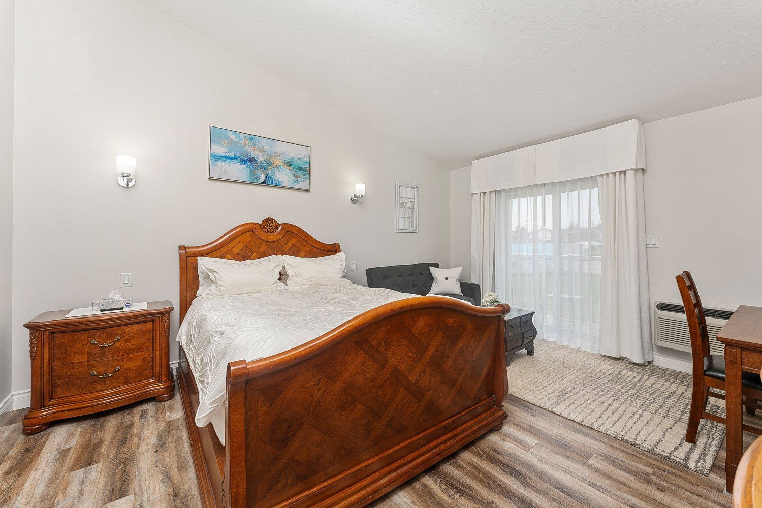 There is a large bed in the middle of the room, with a balcony and lake view