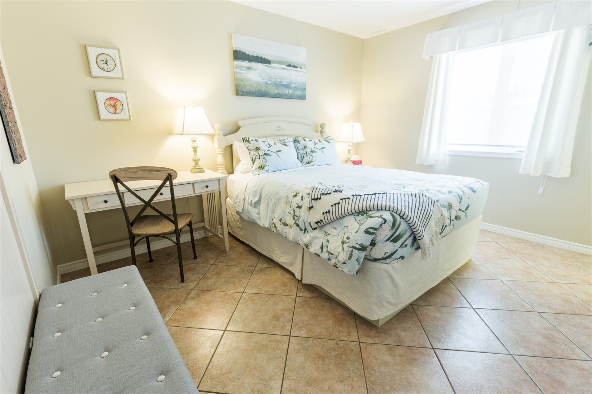 A bedroom with a bed , desk , chair and window. Lakeshore Inn Bed & Breakfast