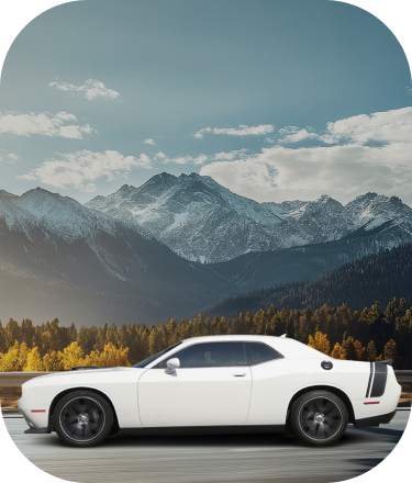 A white suv is driving down a road with mountains in the background.  |  D & B Bear Service