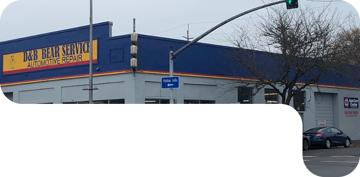 A blue and yellow building with a sign that says 24 hour service  | D & B Bear Service