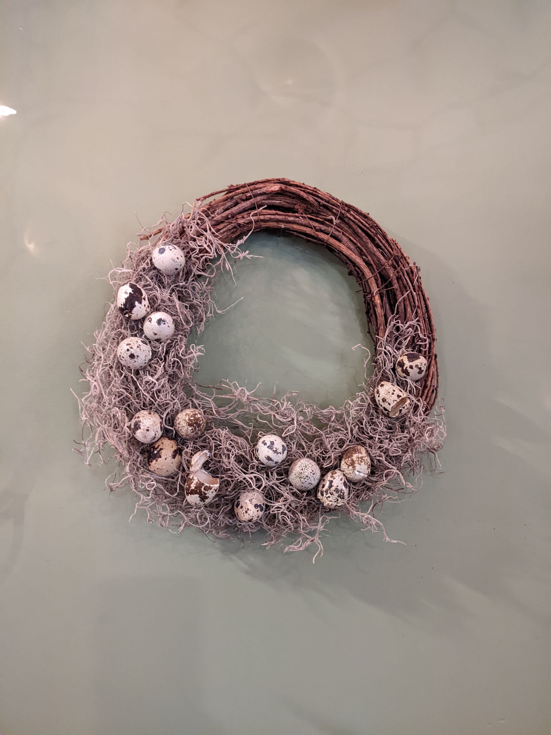 A wreath is sitting on top of a glass table.