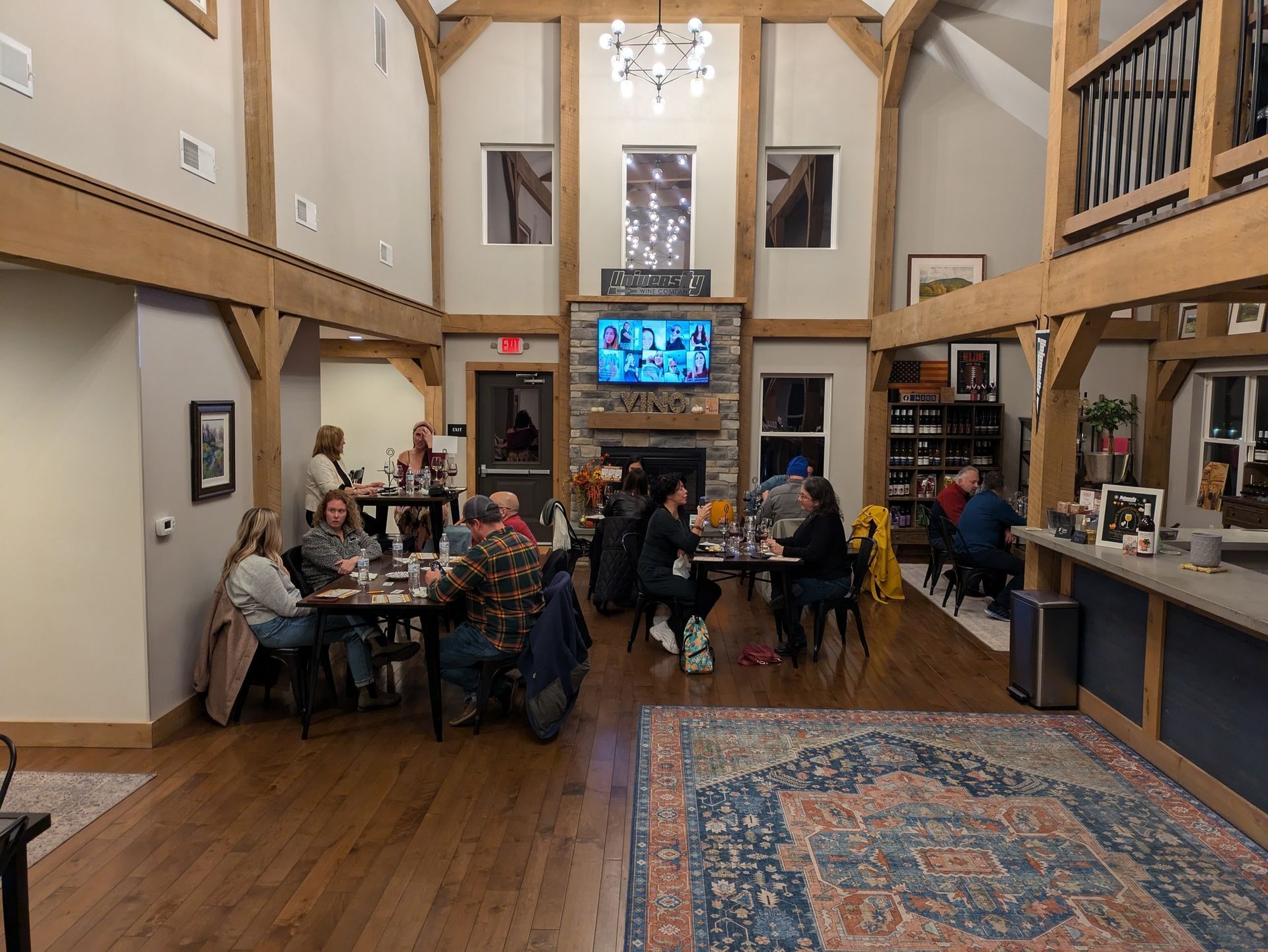 A group of people are sitting at tables in a large room.
