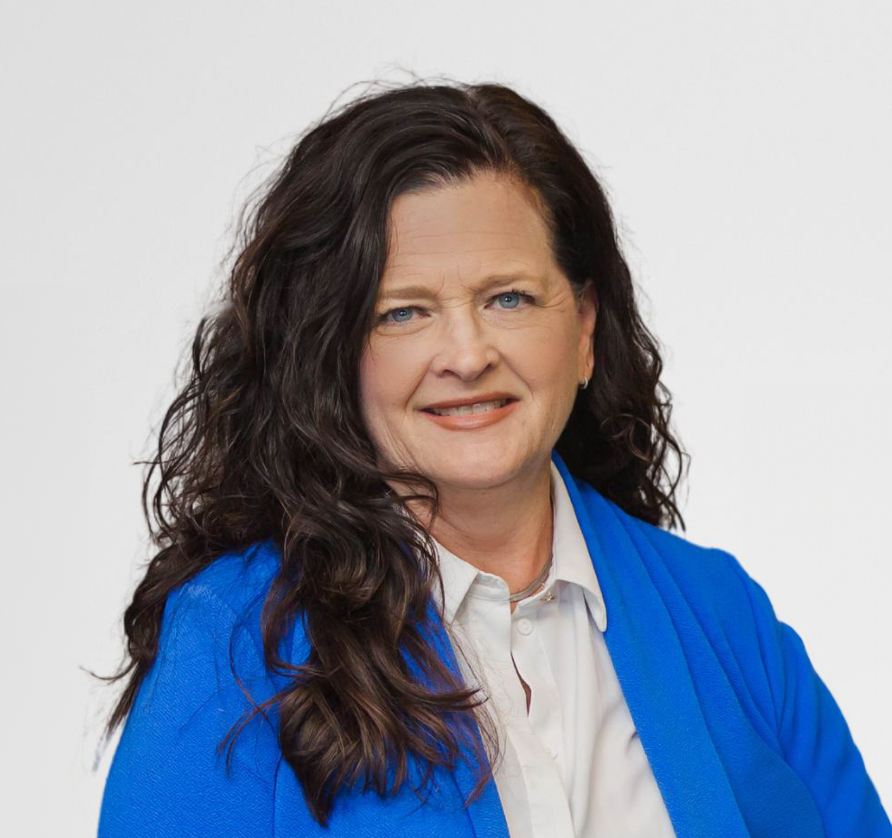 A woman is wearing a blue jacket and a green shirt.