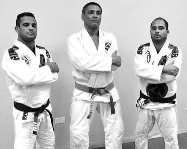 A woman is hugging a young boy on a blue mat