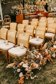 A row of chairs sitting on top of a lush green field.