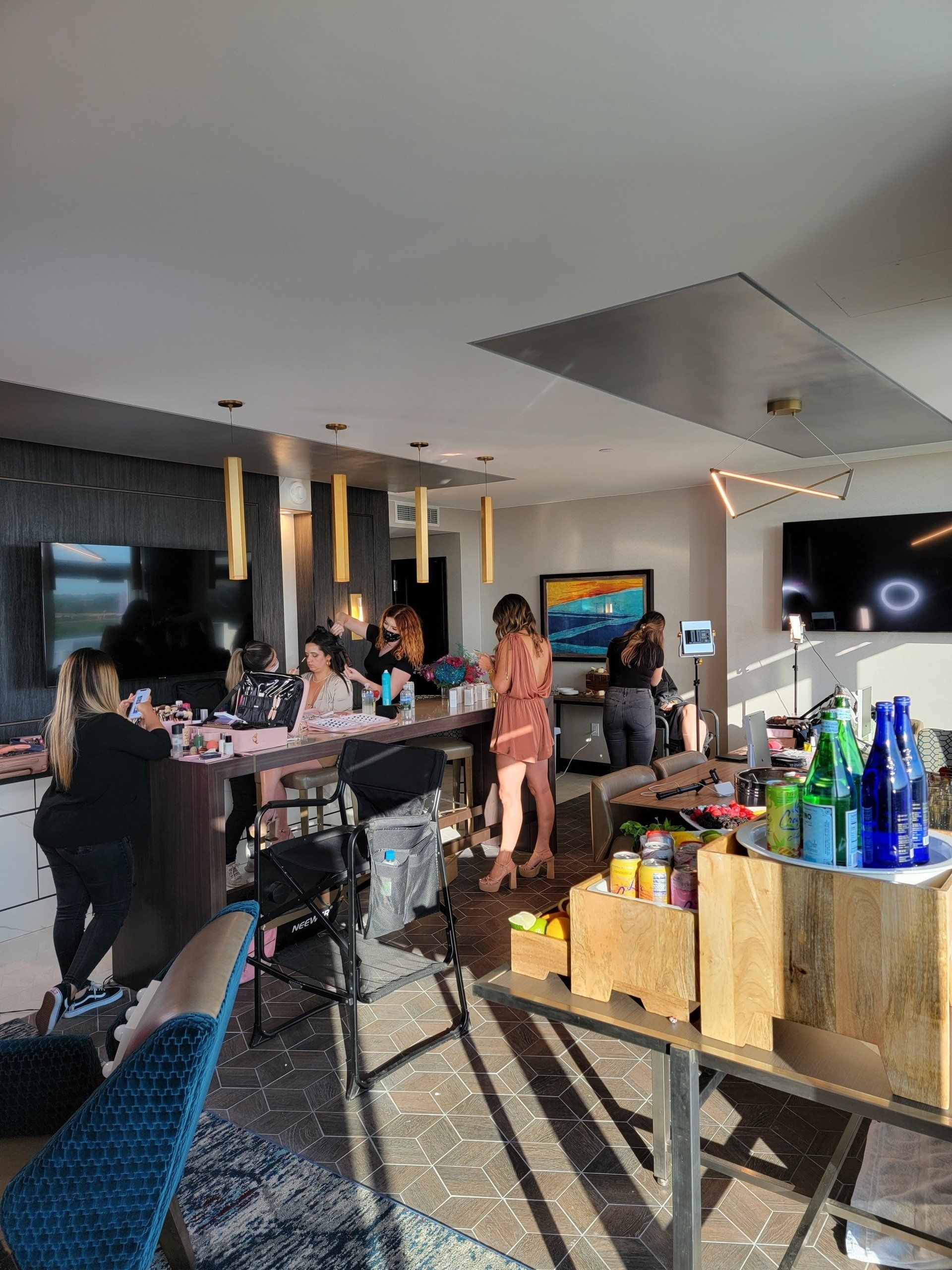 A group of people are standing around a table in a living room.