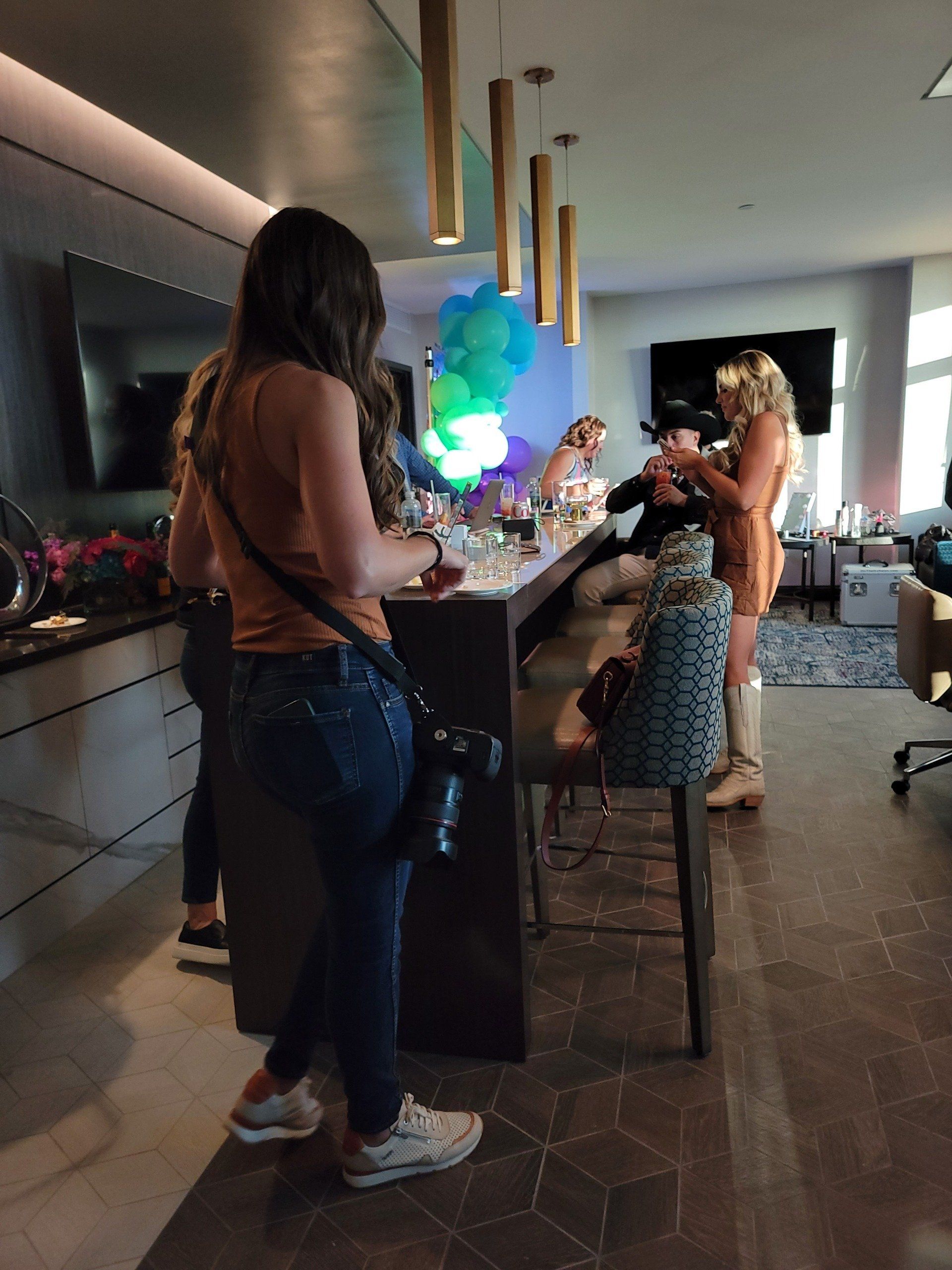 A group of people are standing around a table in a room
