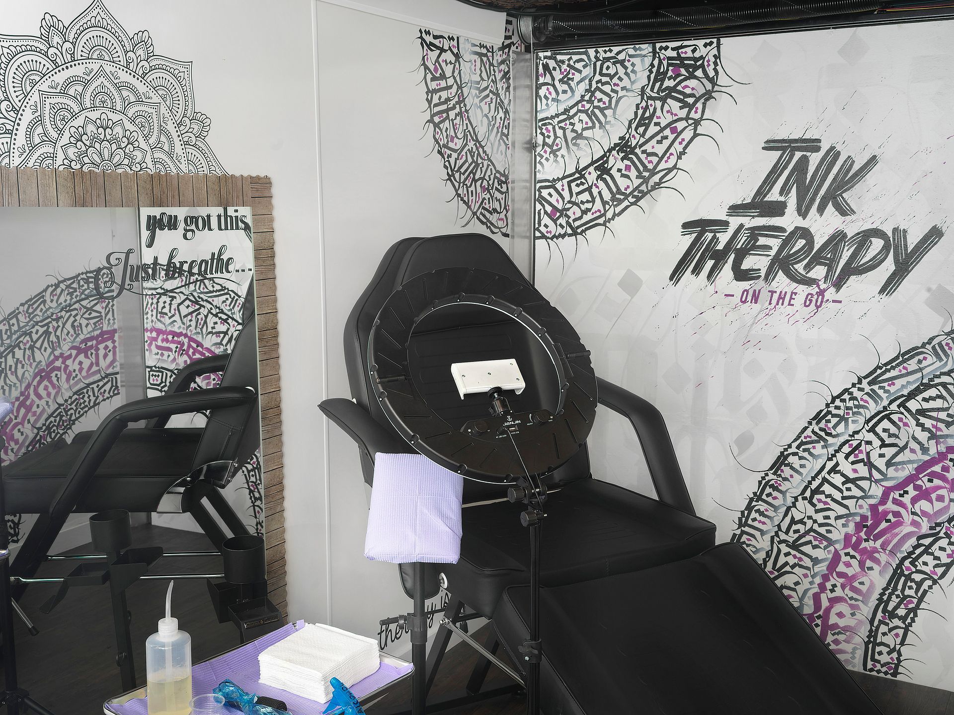 A room with a chair and a sign that says ink therapy