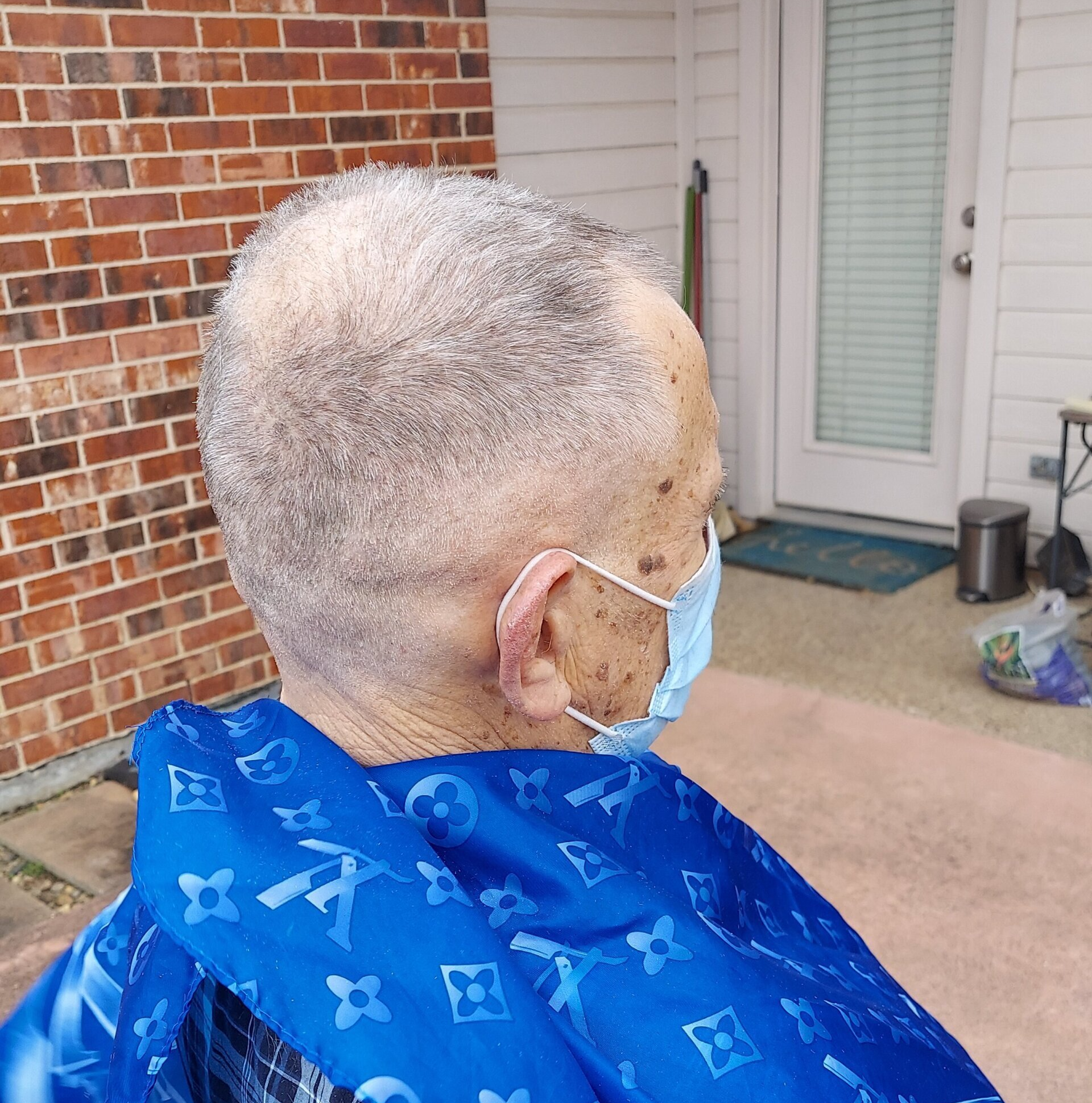 A man wearing a blue cape and a face mask