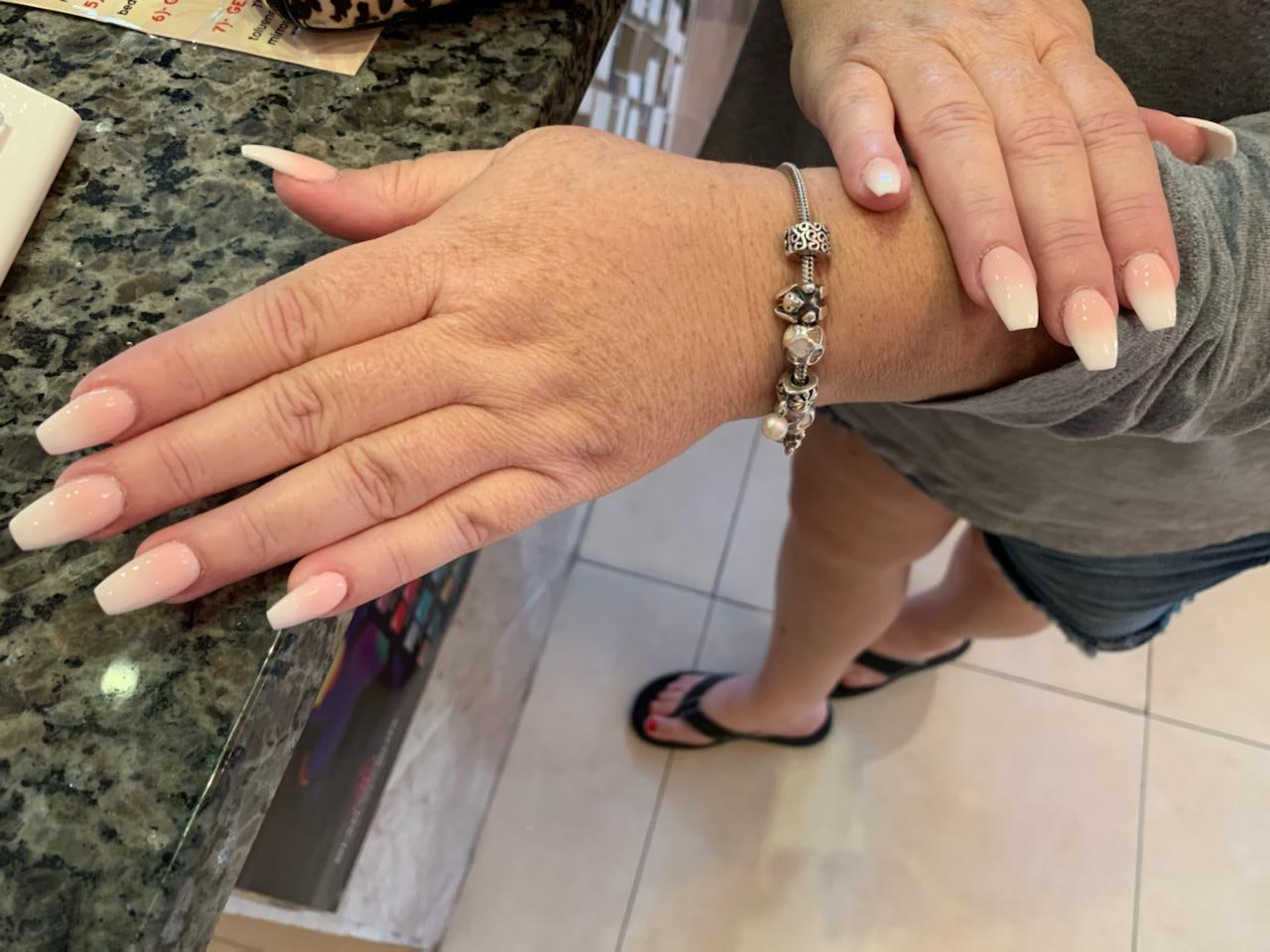 A woman 's hand with a bracelet on her wrist