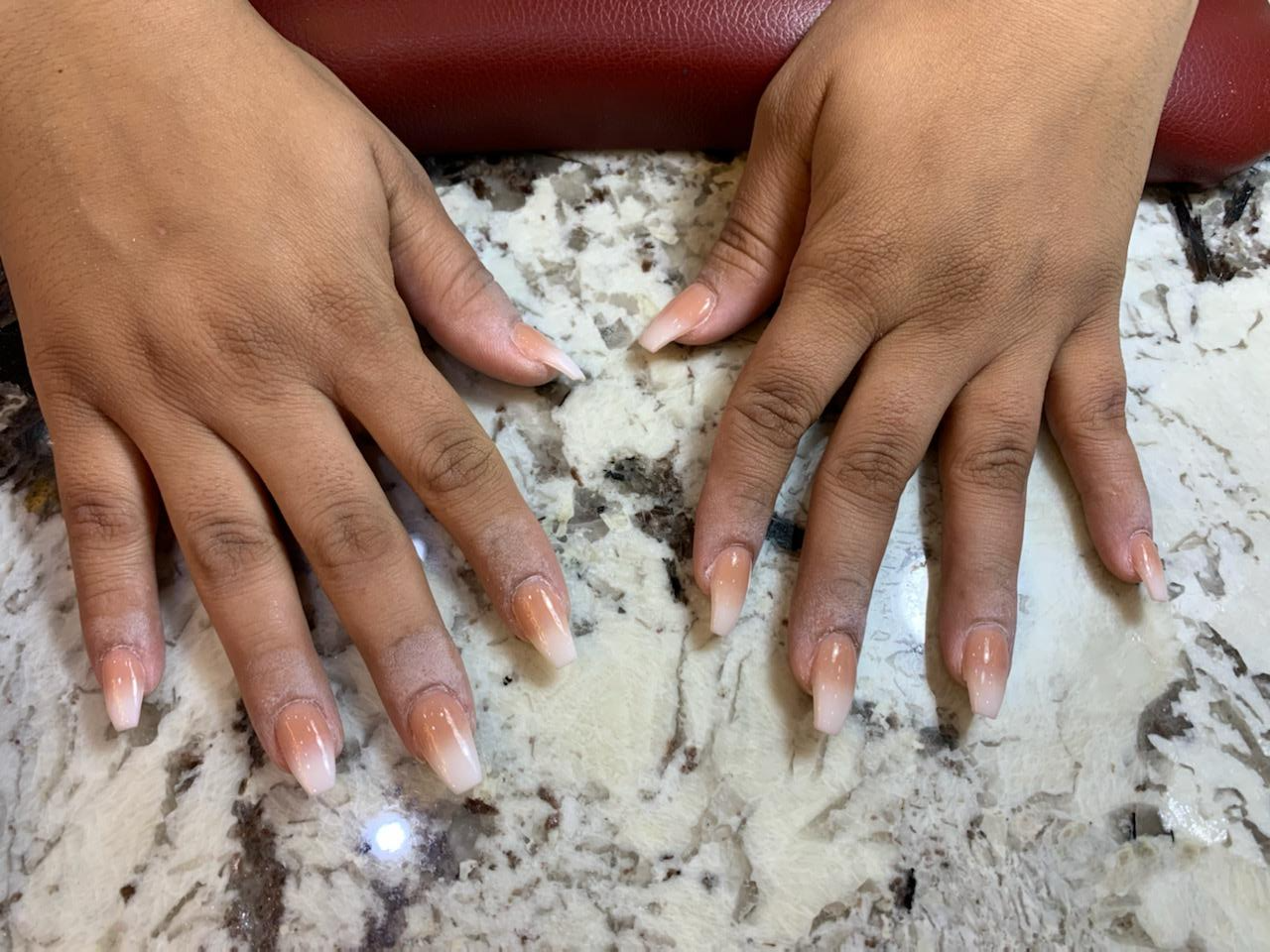 A close up of a person 's hands with long nails