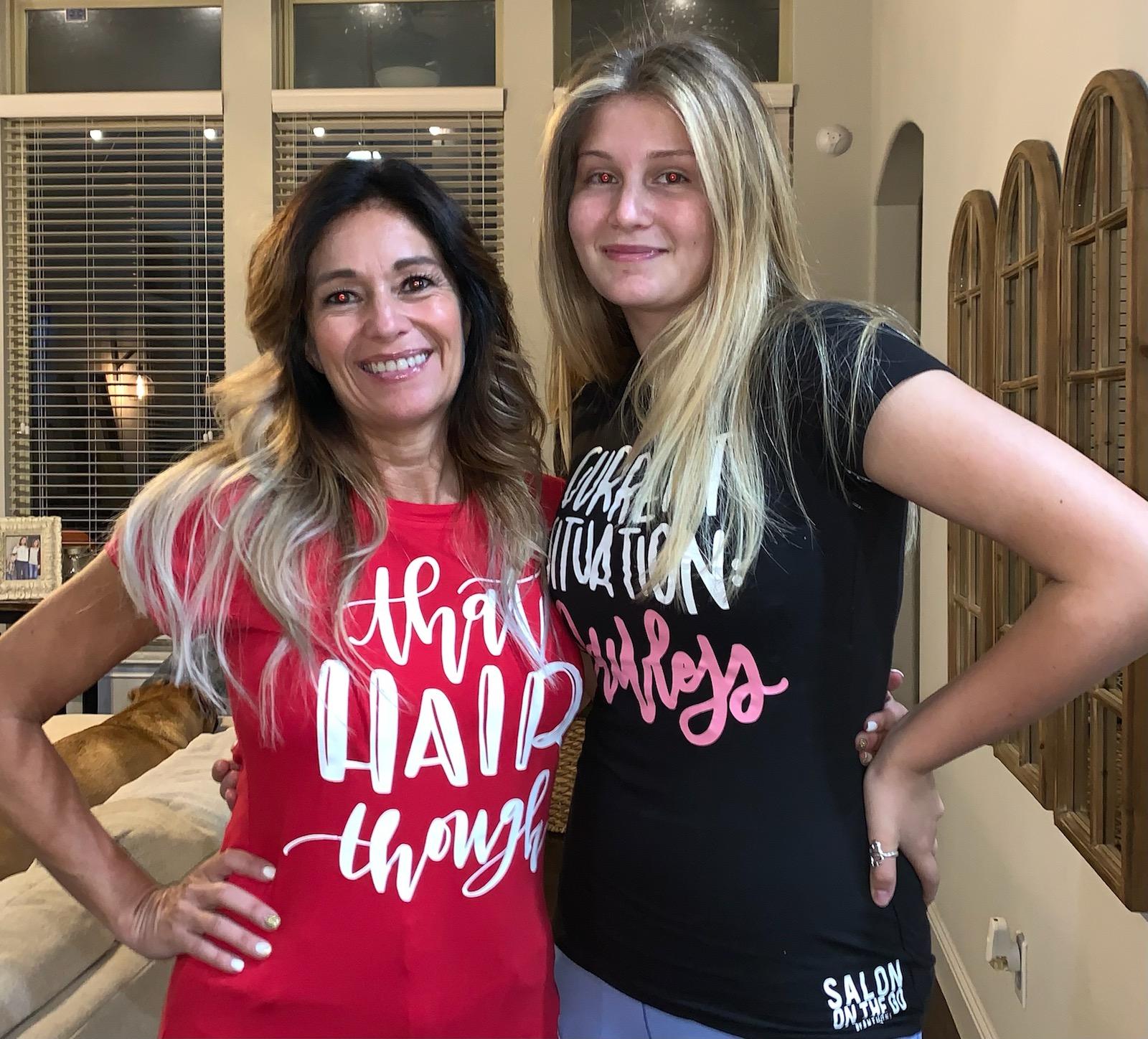 Two women are standing next to each other in a living room.