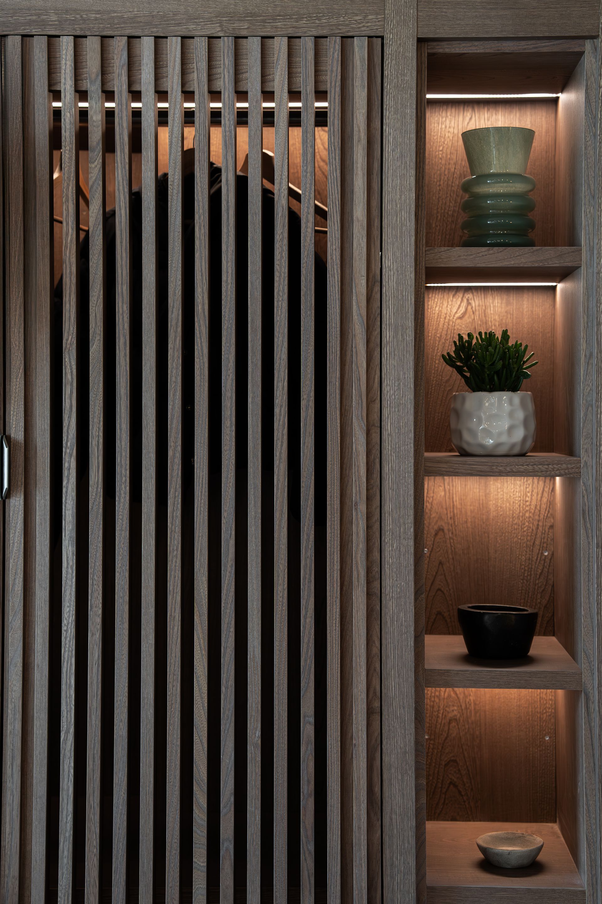 Chalet Escapade A wooden closet with a sliding door and shelves.