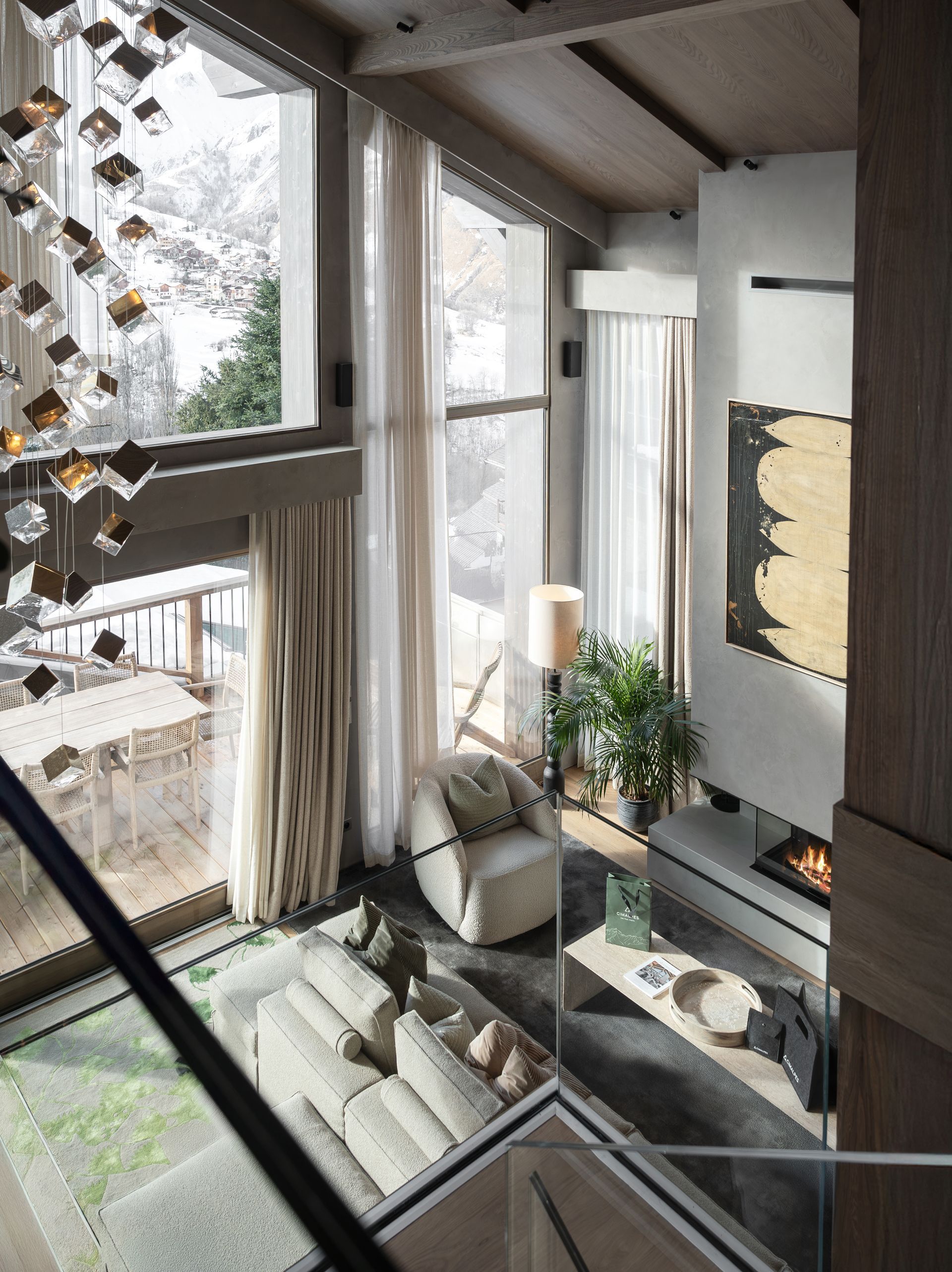 Chalet Escapade A living room with a lot of windows and a fireplace