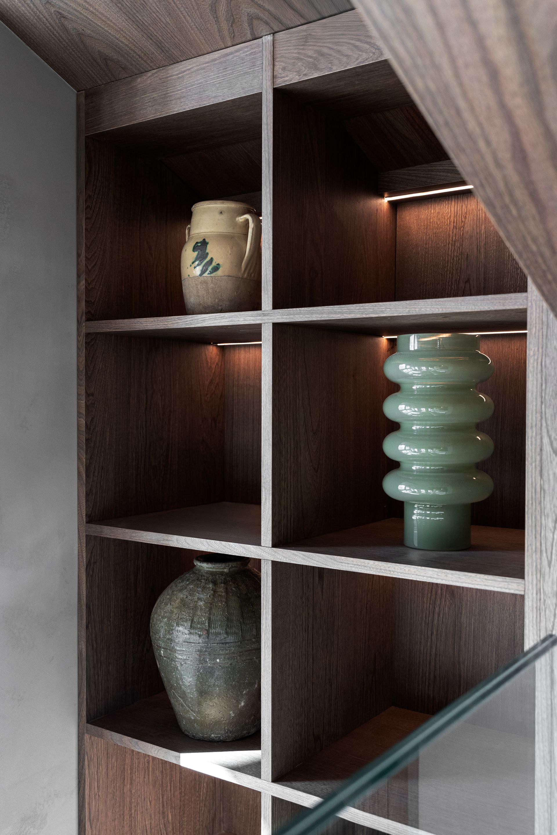 Chalet Escapade A wooden shelf with vases and a lamp on it.