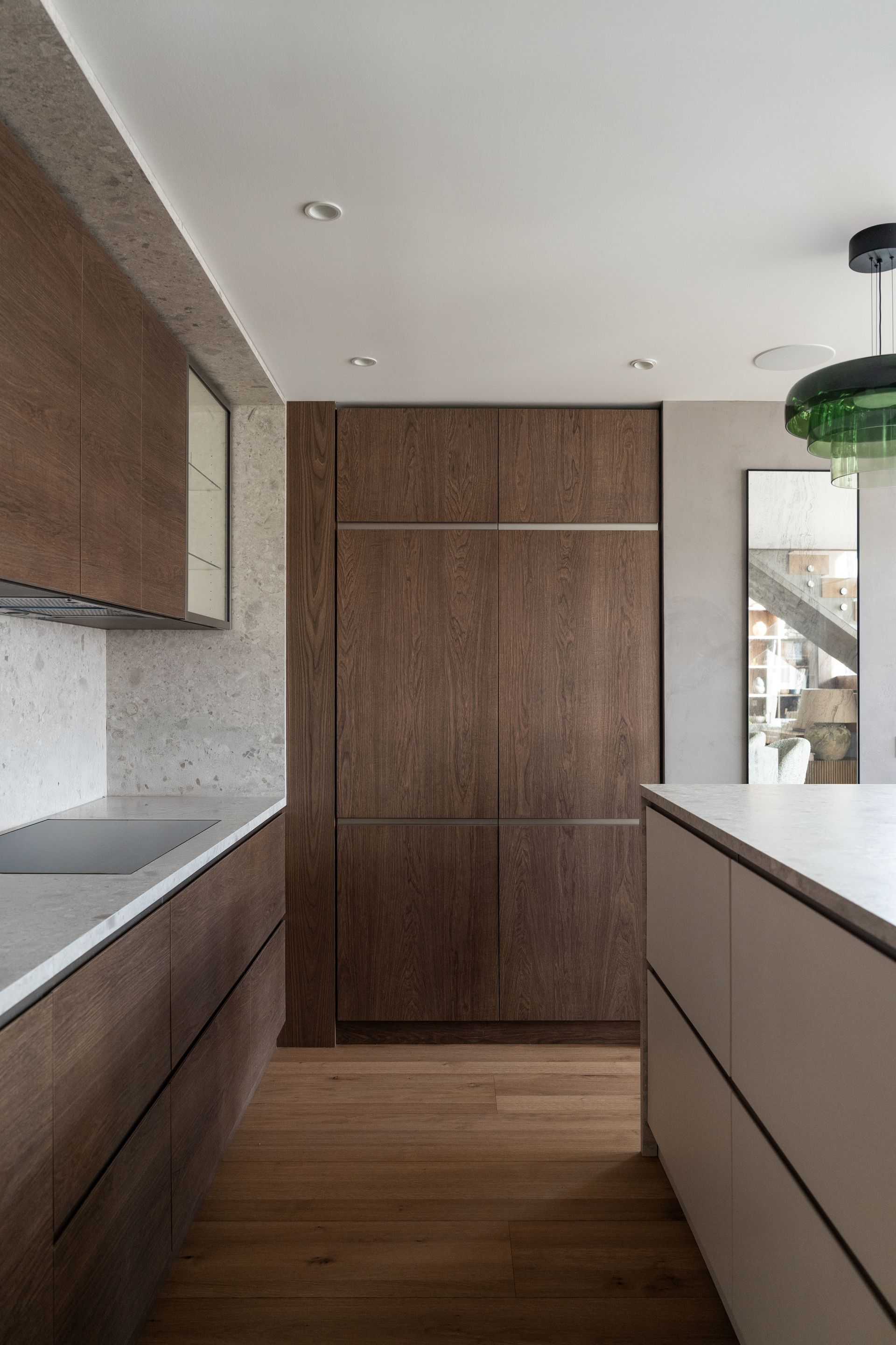 Chalet Escapade A kitchen with wooden cabinets and white counter tops.