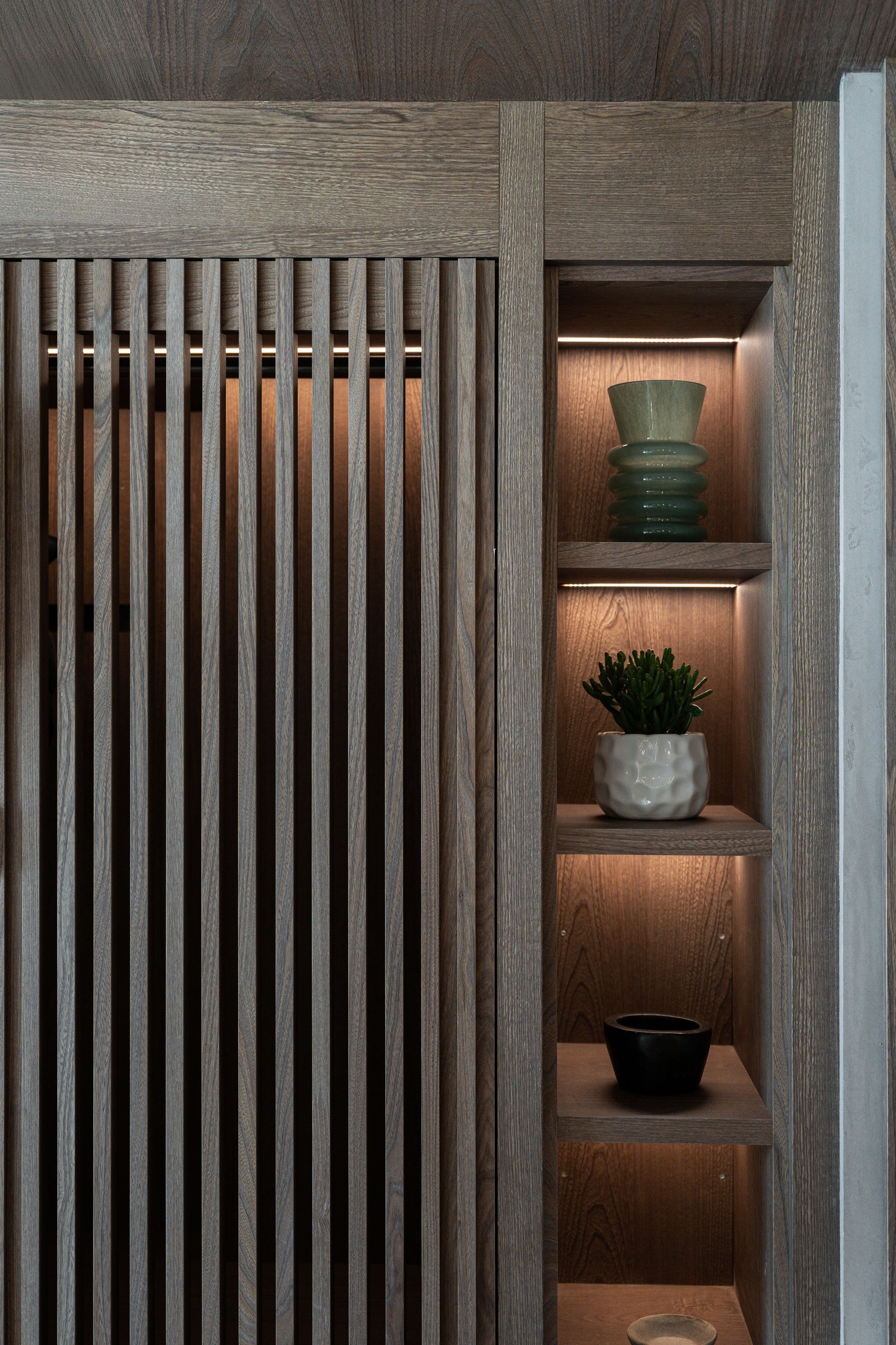 Chalet Escapade A wooden wall with a shelf and a plant on it.