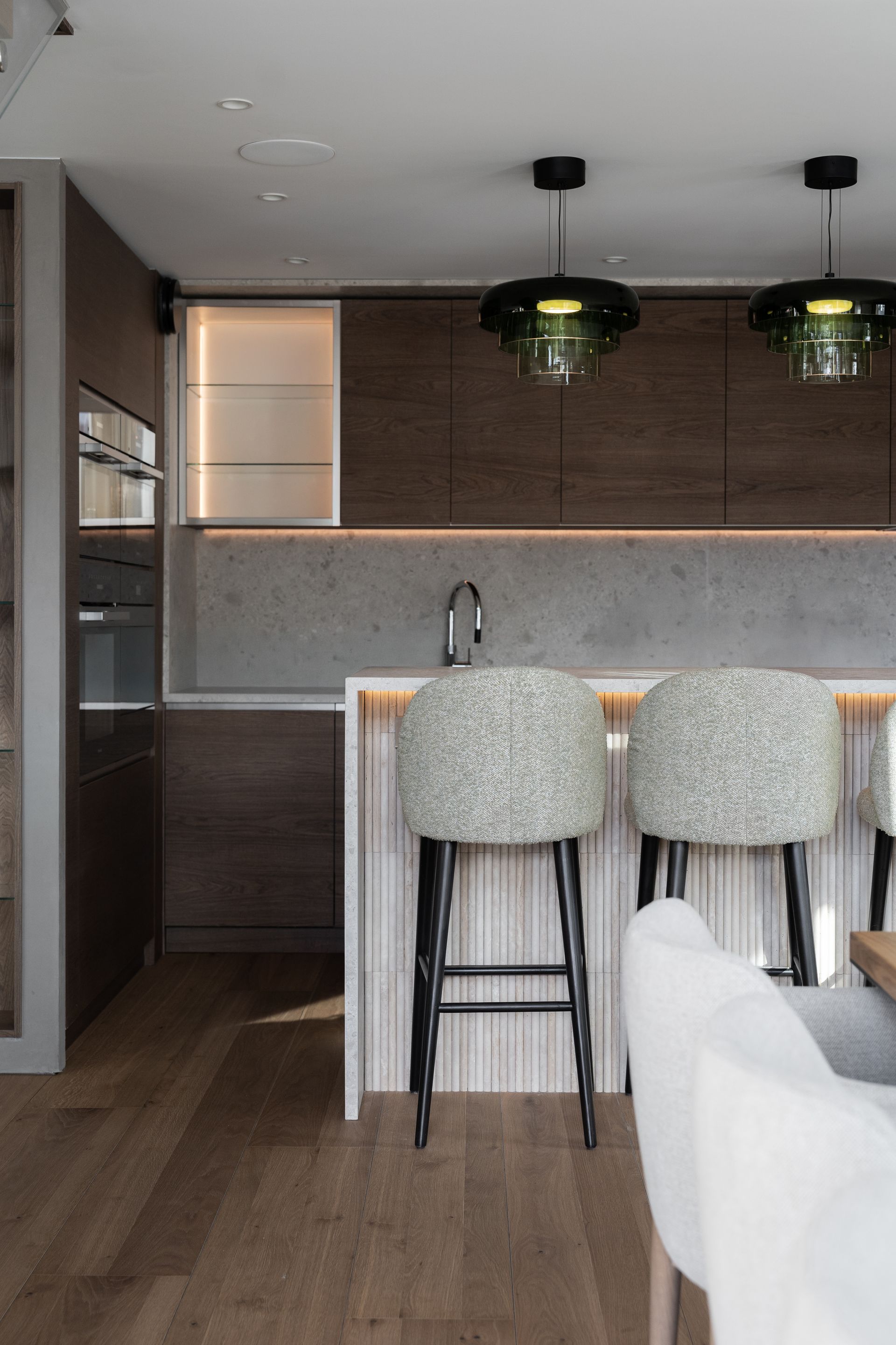 Chalet Escapade A kitchen with two bar stools and a sink.