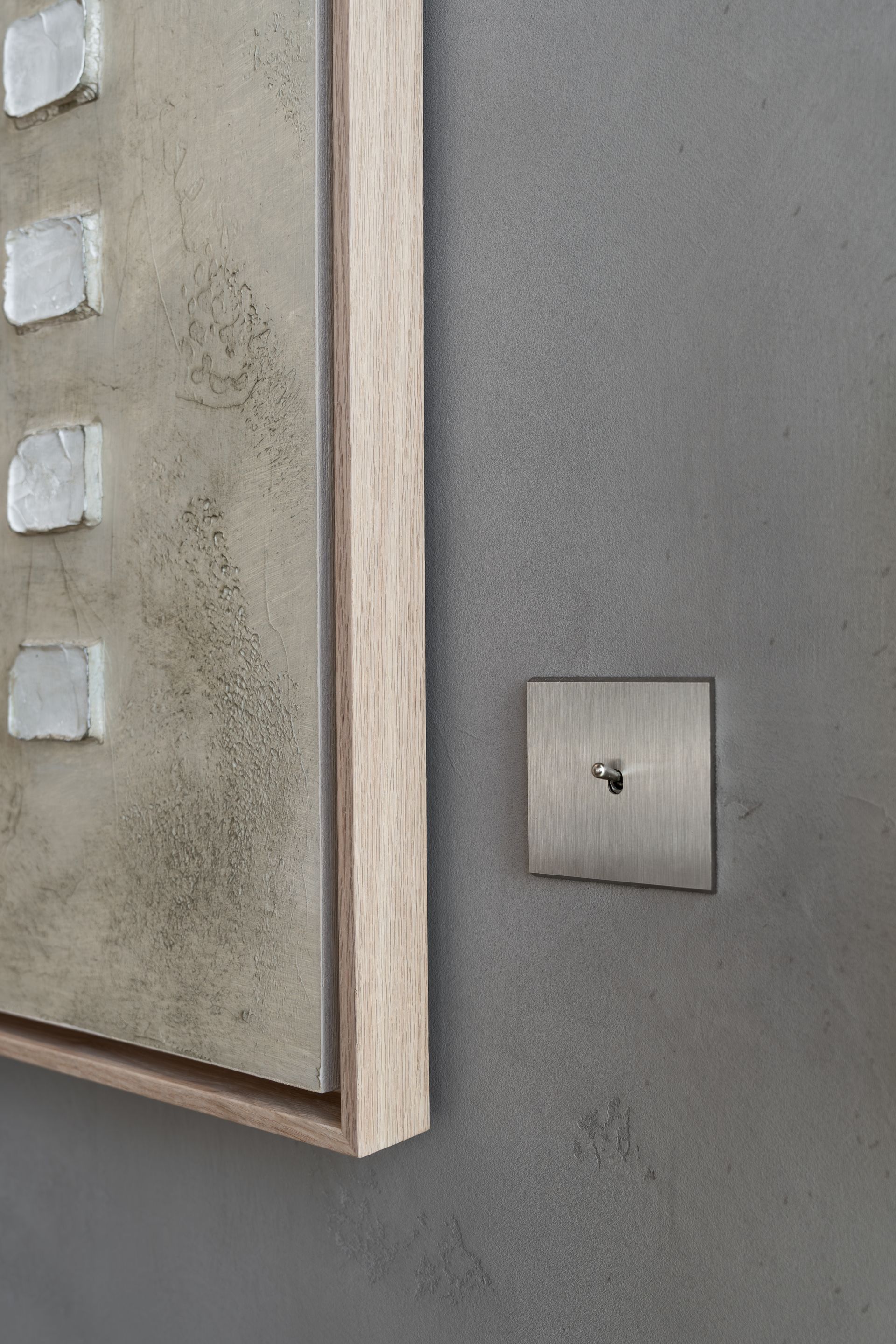 Chalet Escapade A picture is hanging on a wall next to a light switch.