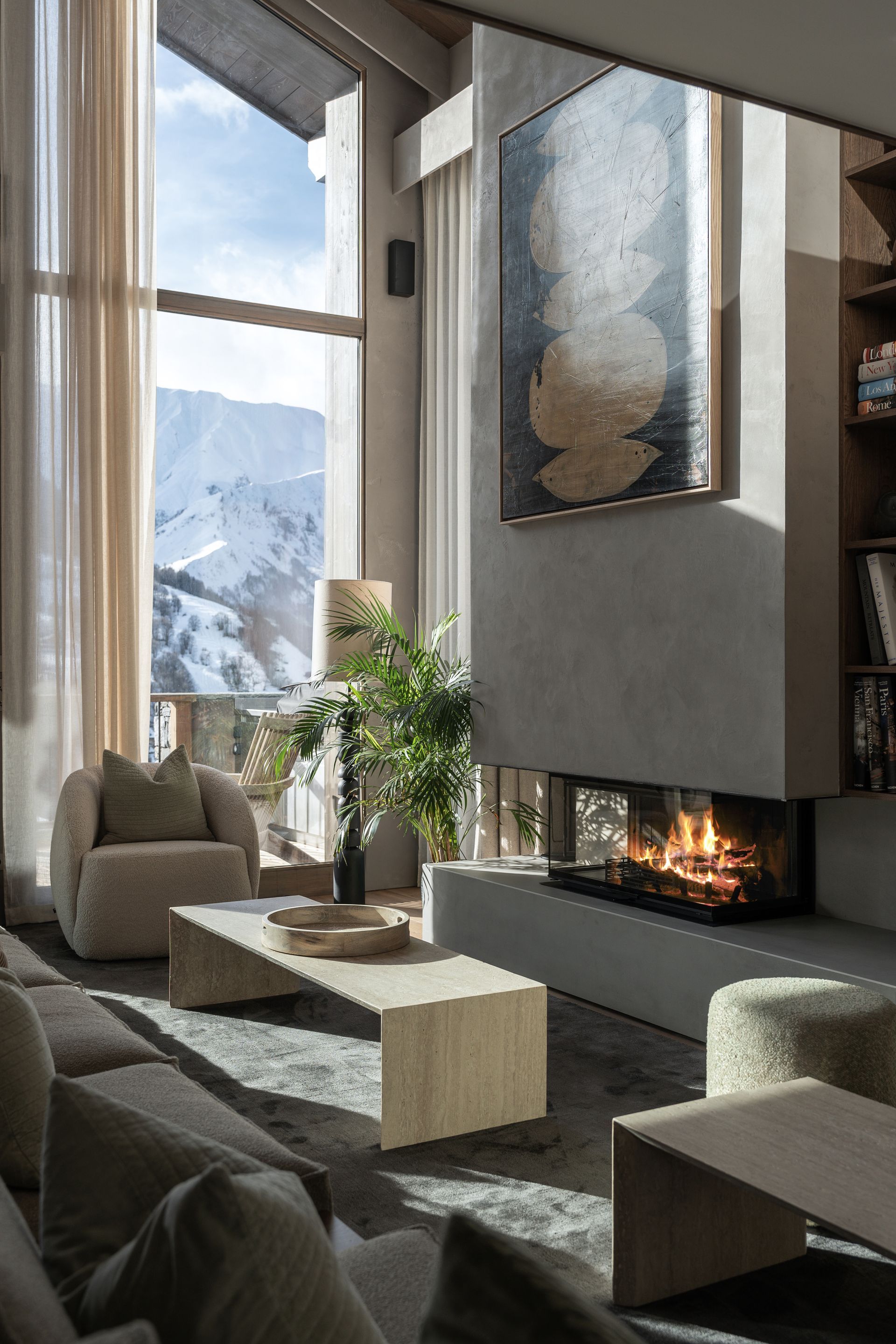 Chalet Escapade A living room with a fireplace and a large window.