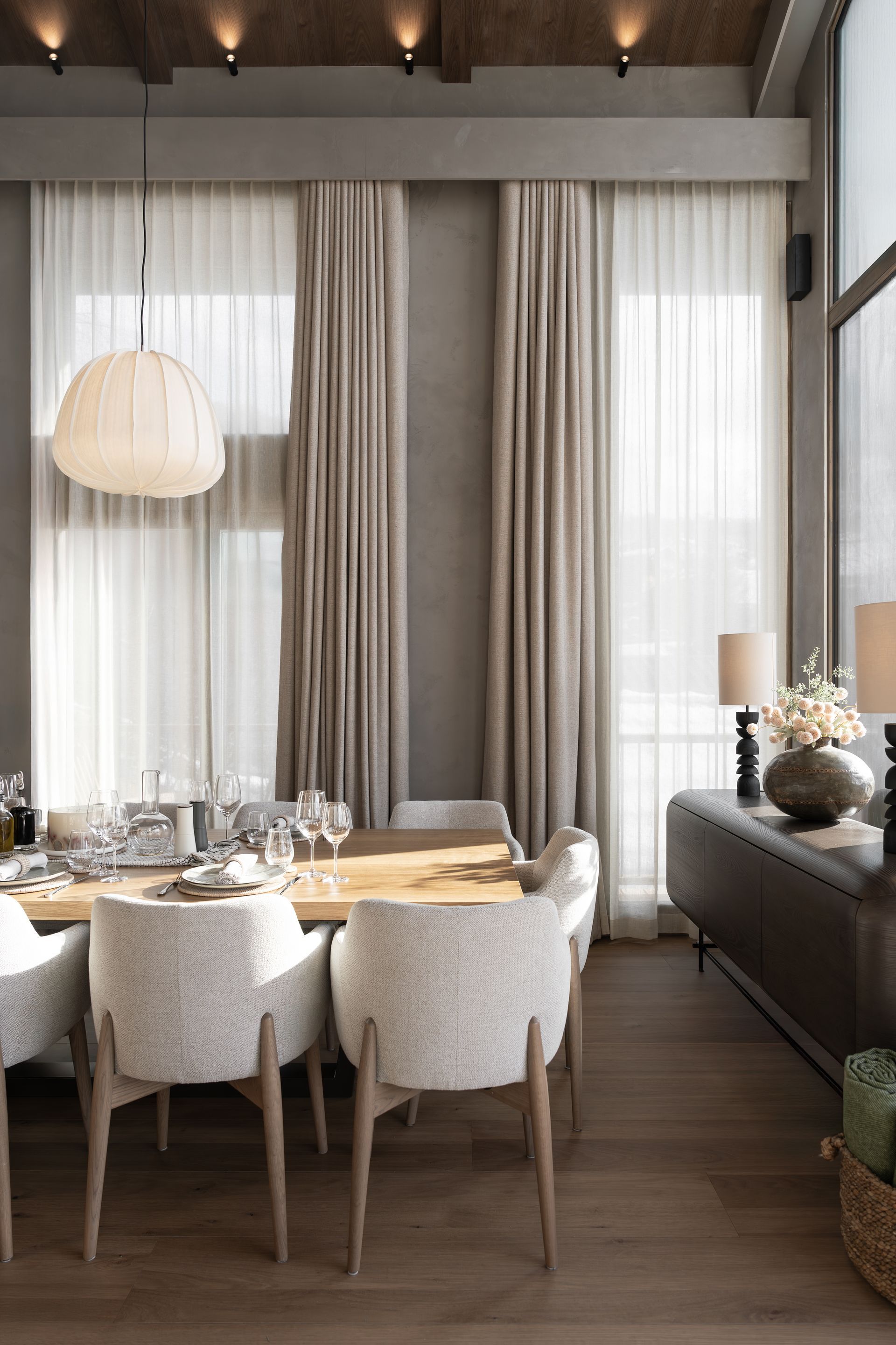 Chalet Escapade A dining room with a table and chairs and a large window.