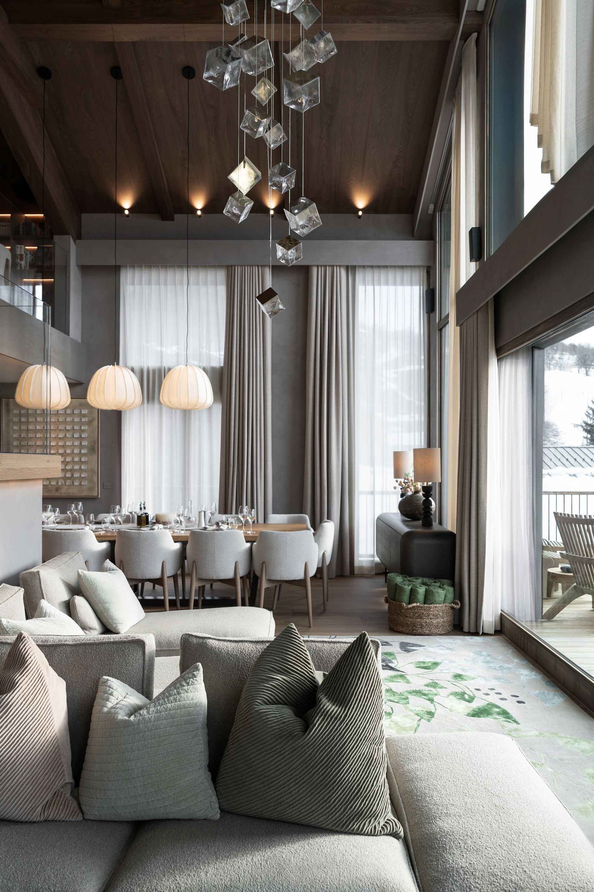 Chalet Escapade A living room with a couch and a dining room in the background.