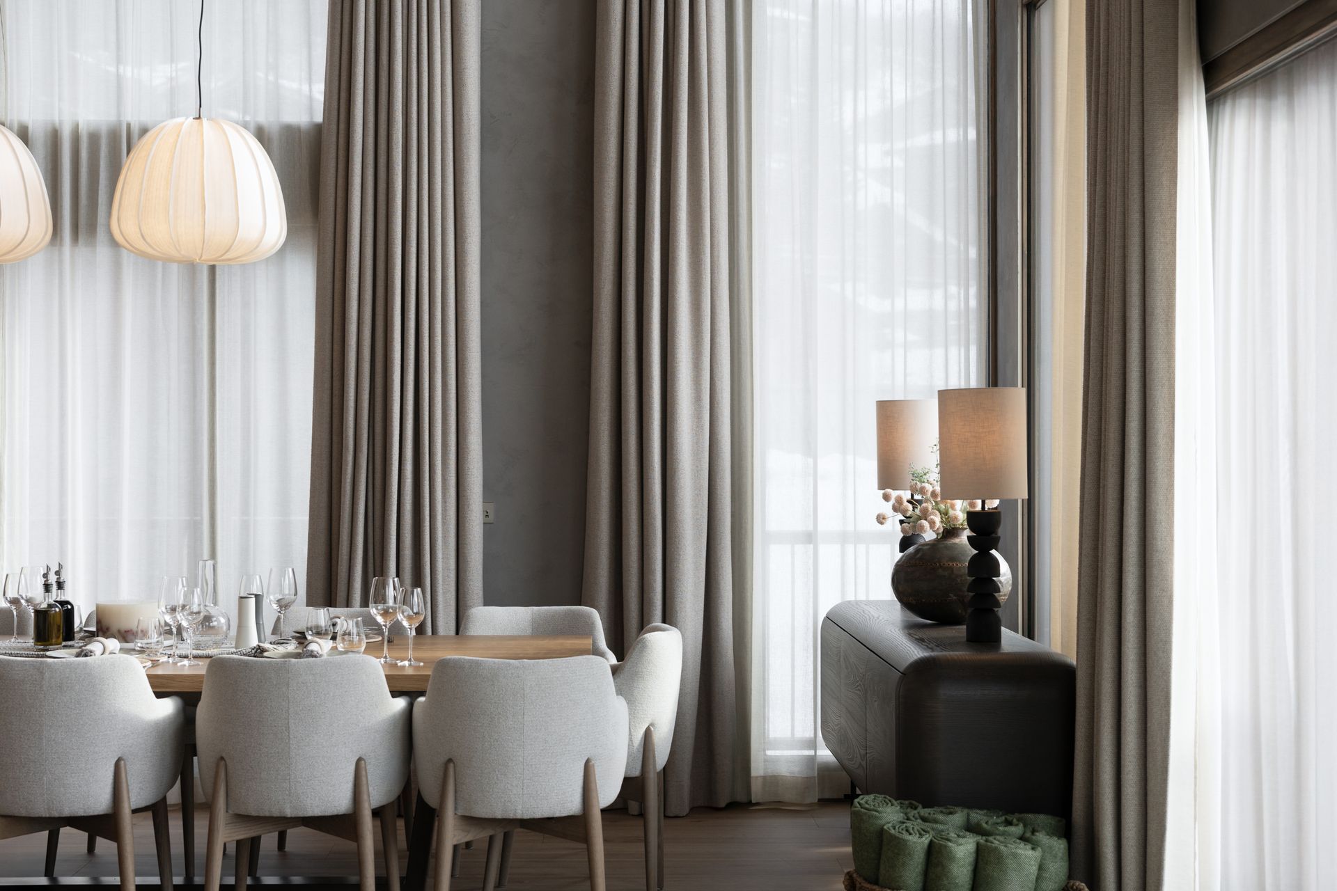 Chalet Escapade A dining room with a table and chairs and curtains