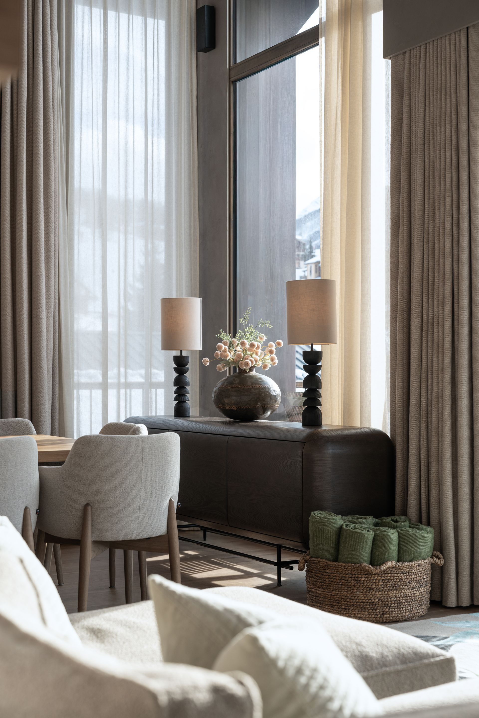 Chalet Escapade A living room with a couch , chairs , tables and lamps.