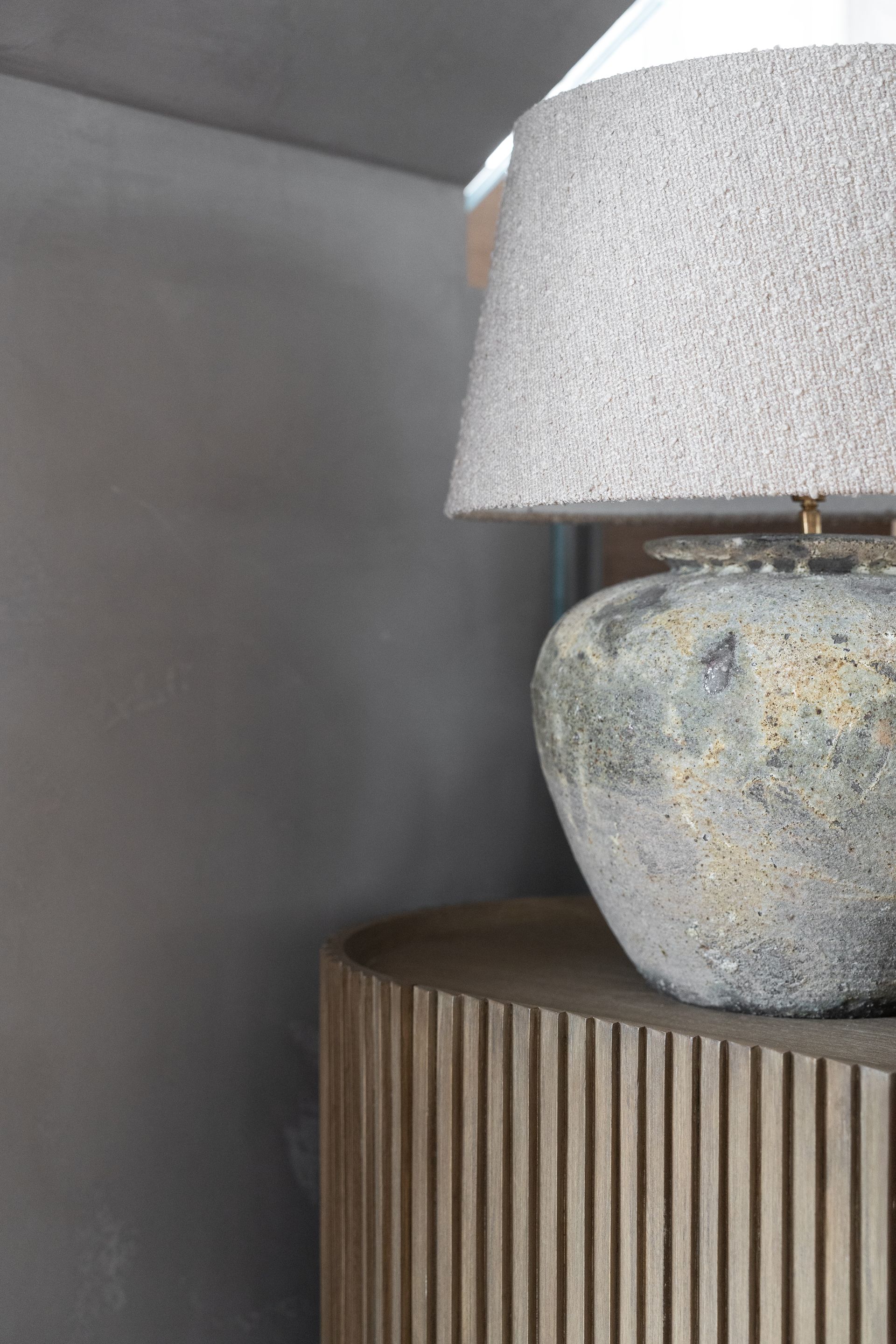 Chalet Escapade A lamp is sitting on top of a wooden table next to a wall.